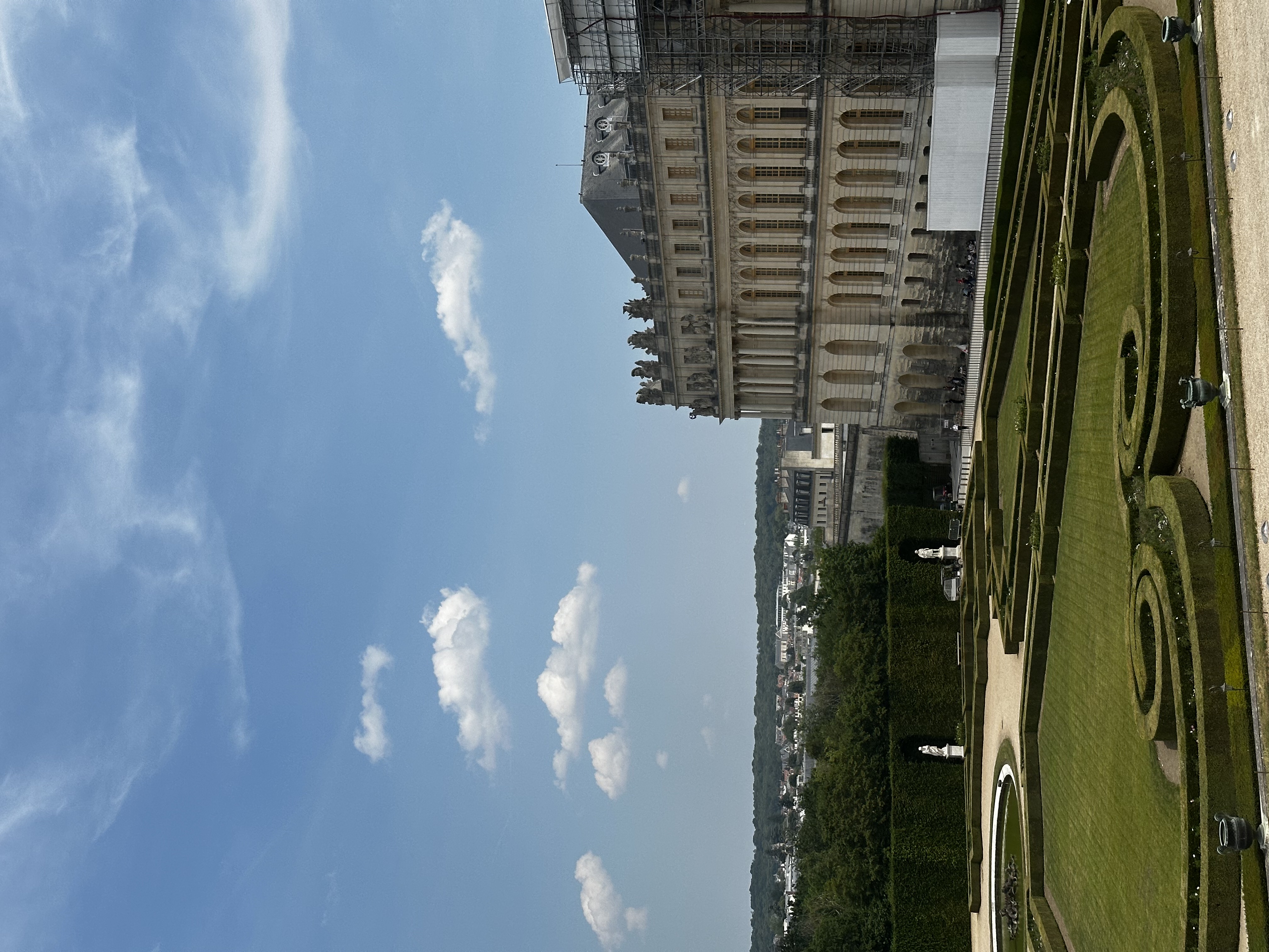 Pretty view of a large building looking over a manicured green lawn on a sunny day
