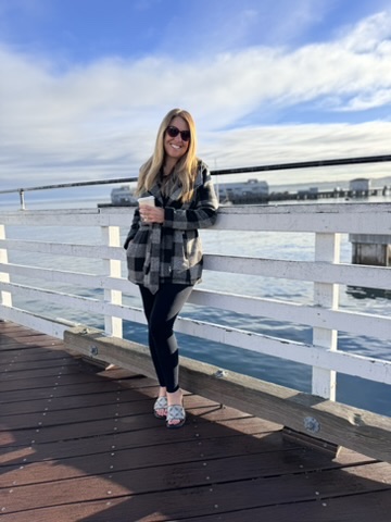 Standing in front of water views during the day.