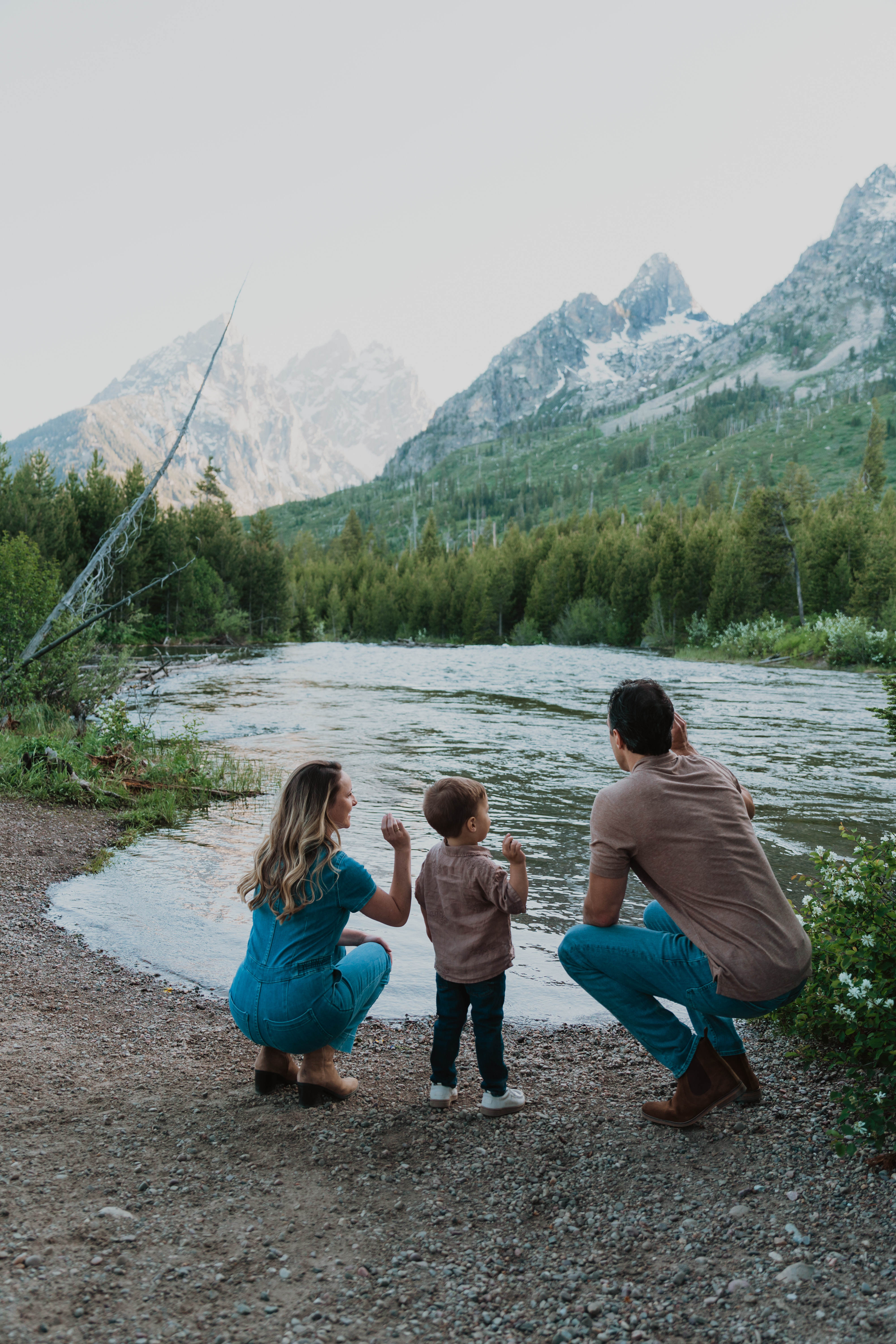 Family looking over water with mountains in the background.