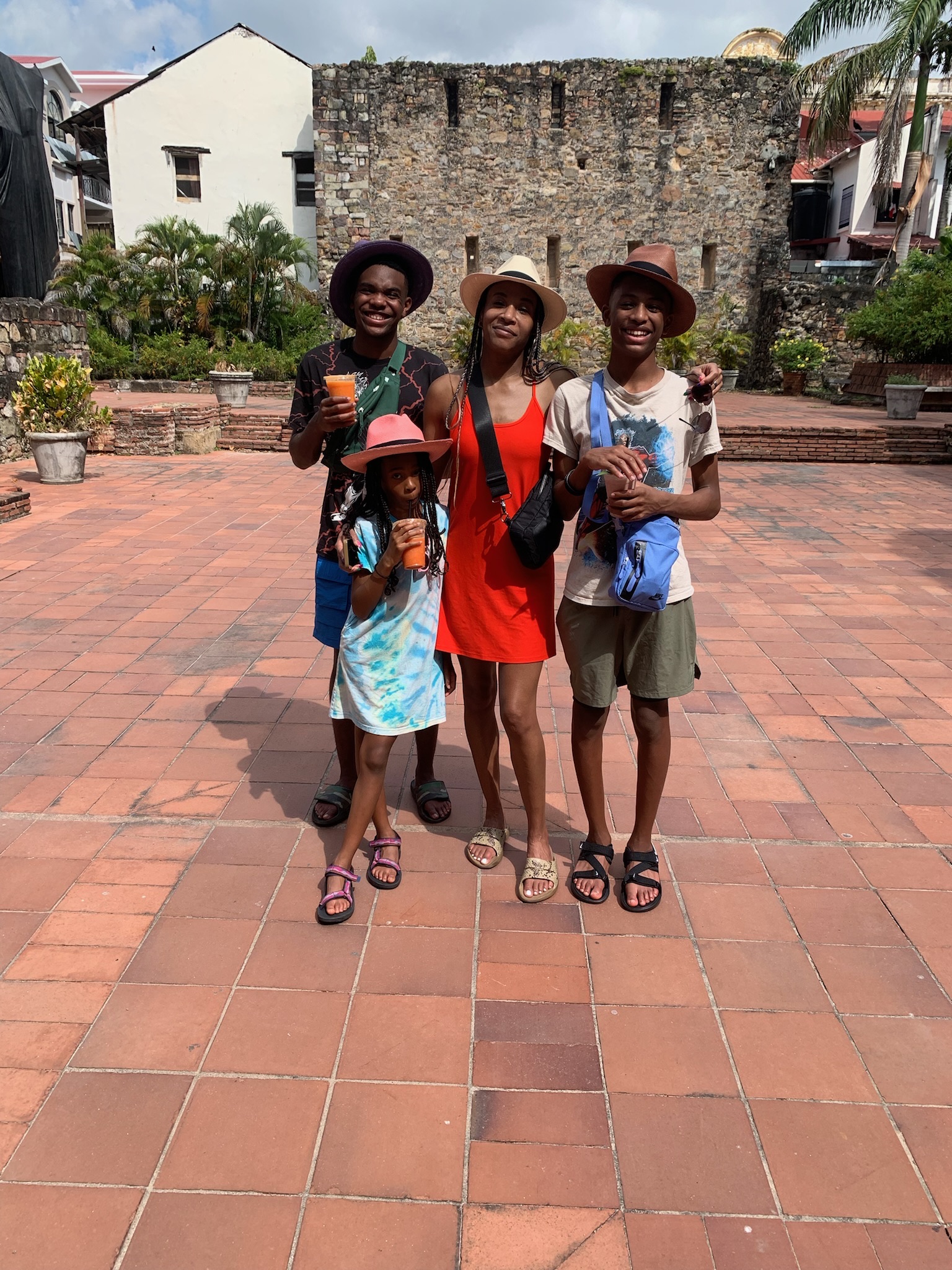 A family standing in front of a historical looking building.