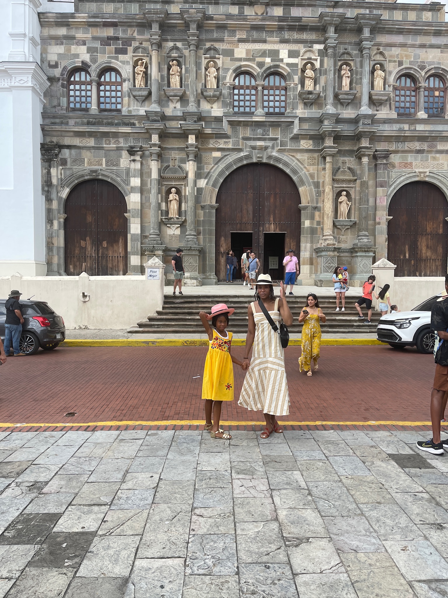 A family in front of a historical looking building.