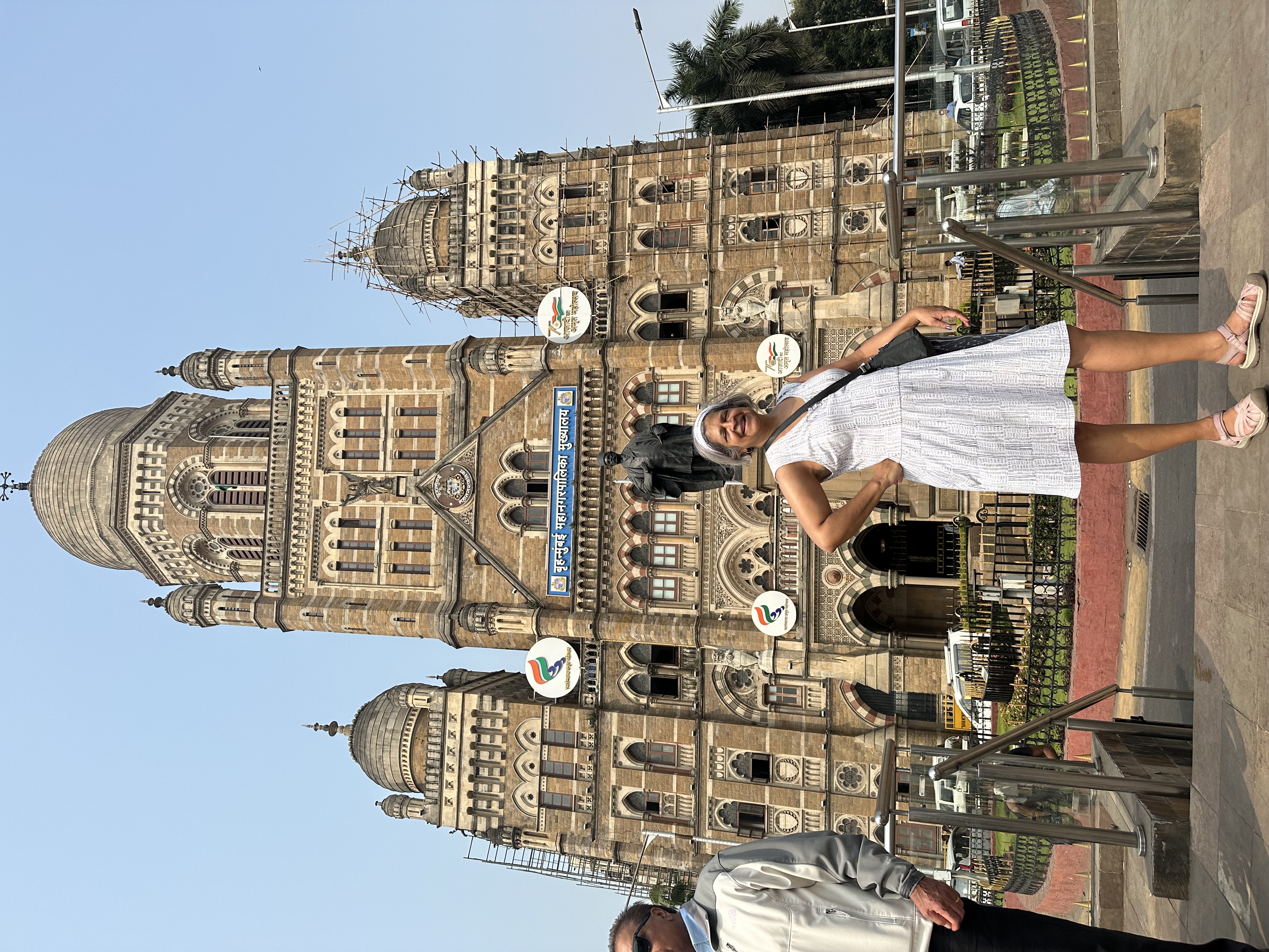 Advisor posing in front of historic building on a sunny day.