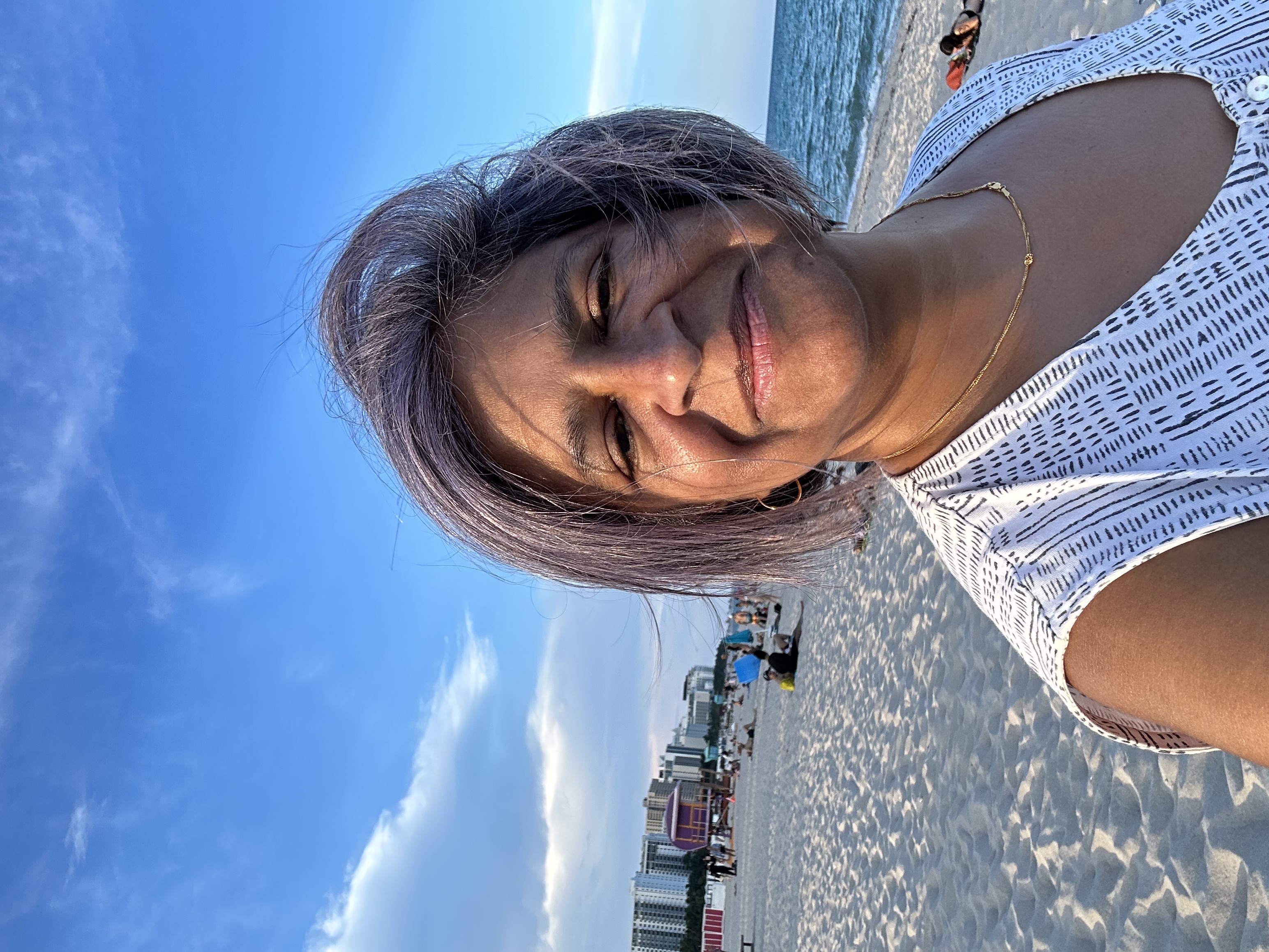 Advisor posing on a beach on a sunny day.