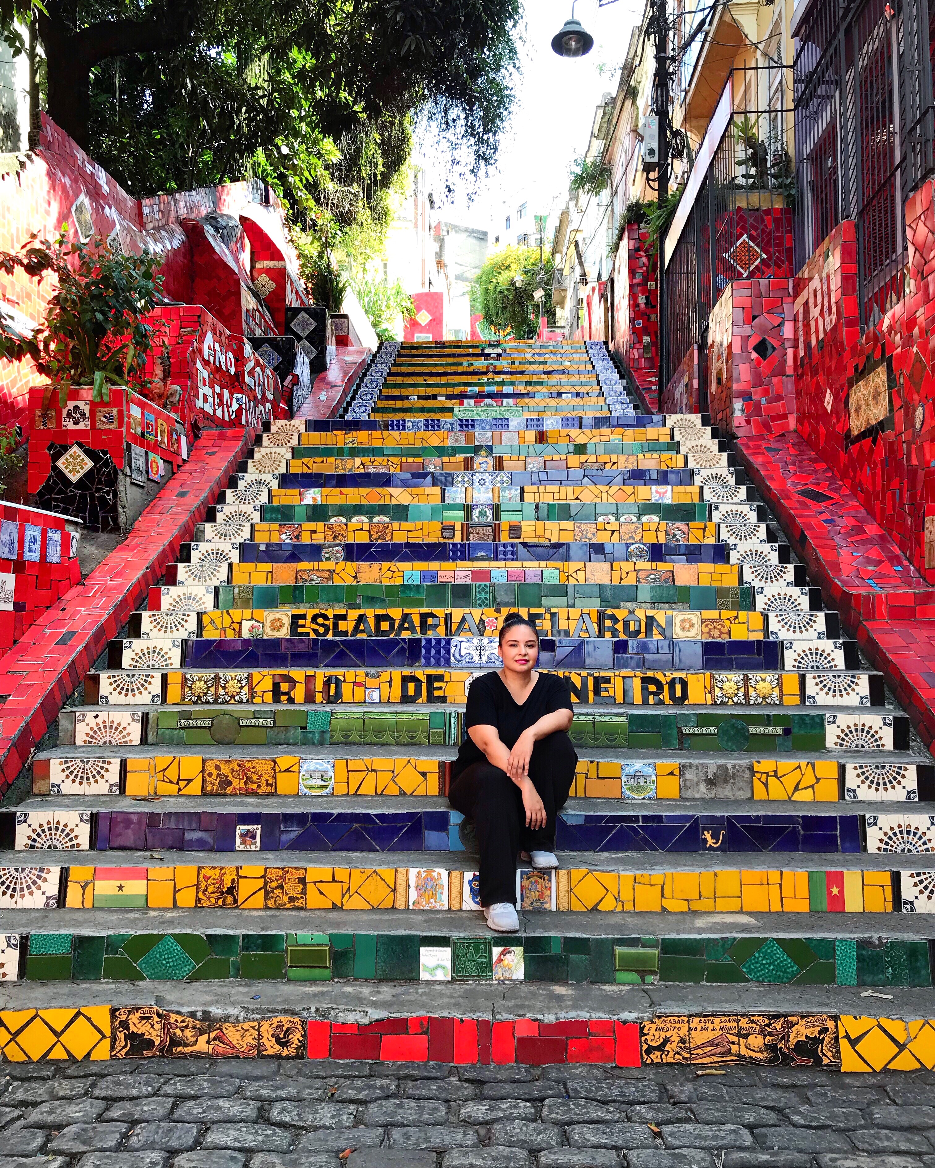 Sitting on colorful painted stairs in the day.