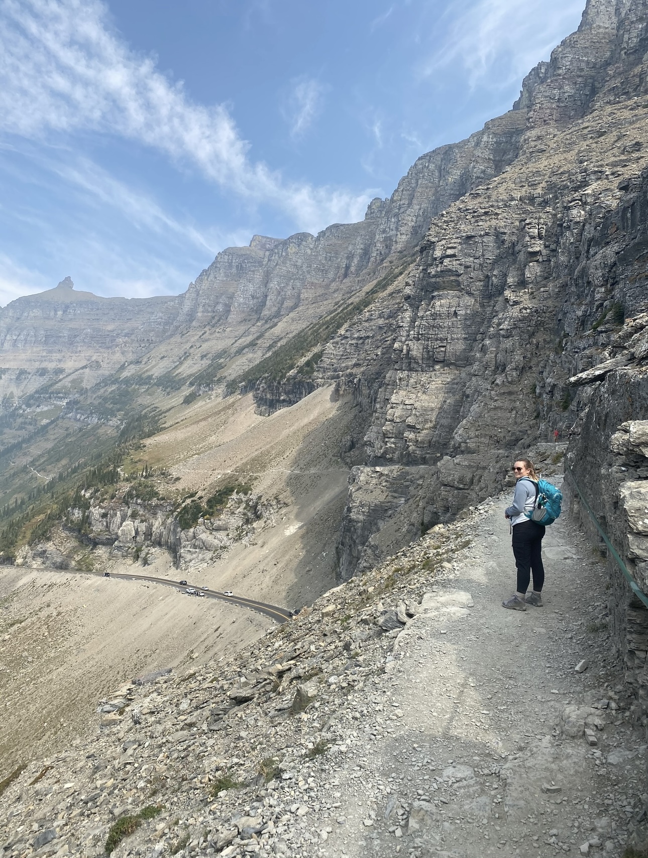 Advisor walking on a dirt path atop a hill during the daytime.