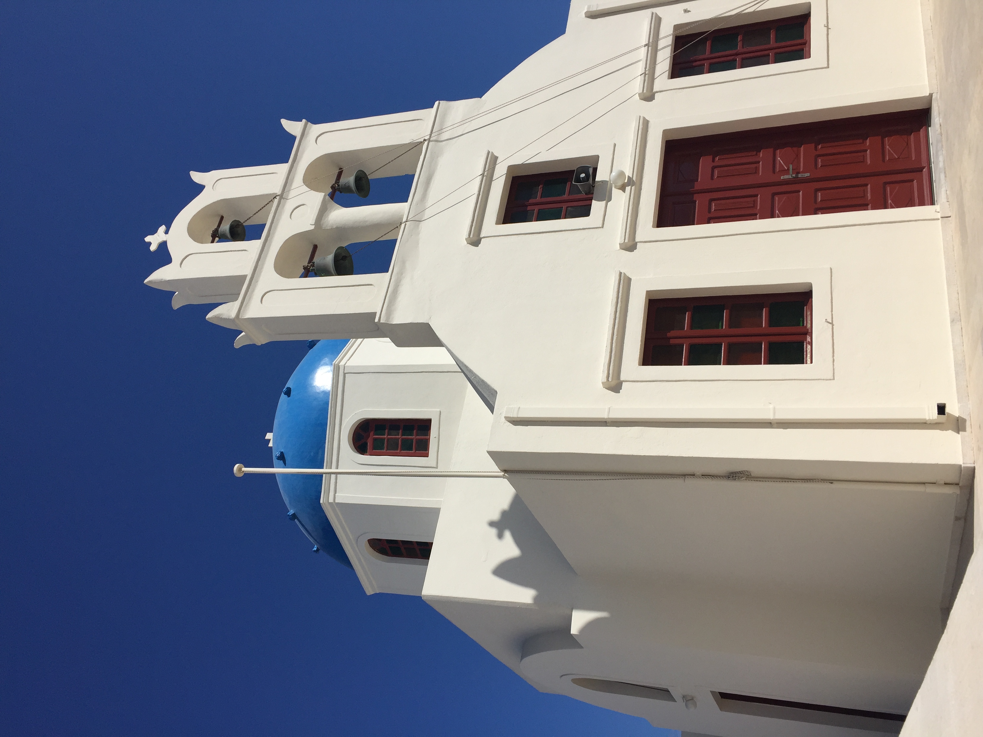 View of a white building with blue dome on a clear day