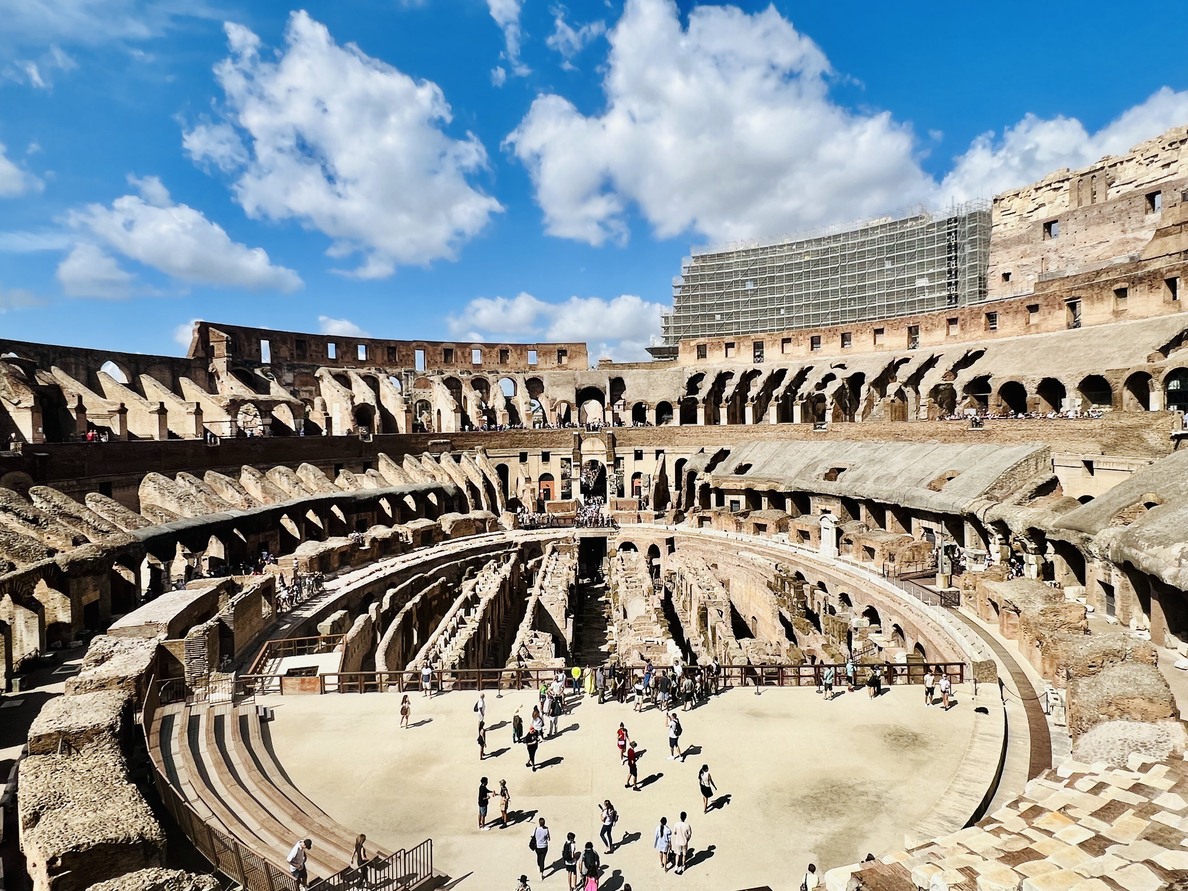Image of an ancient colosseum during the day.