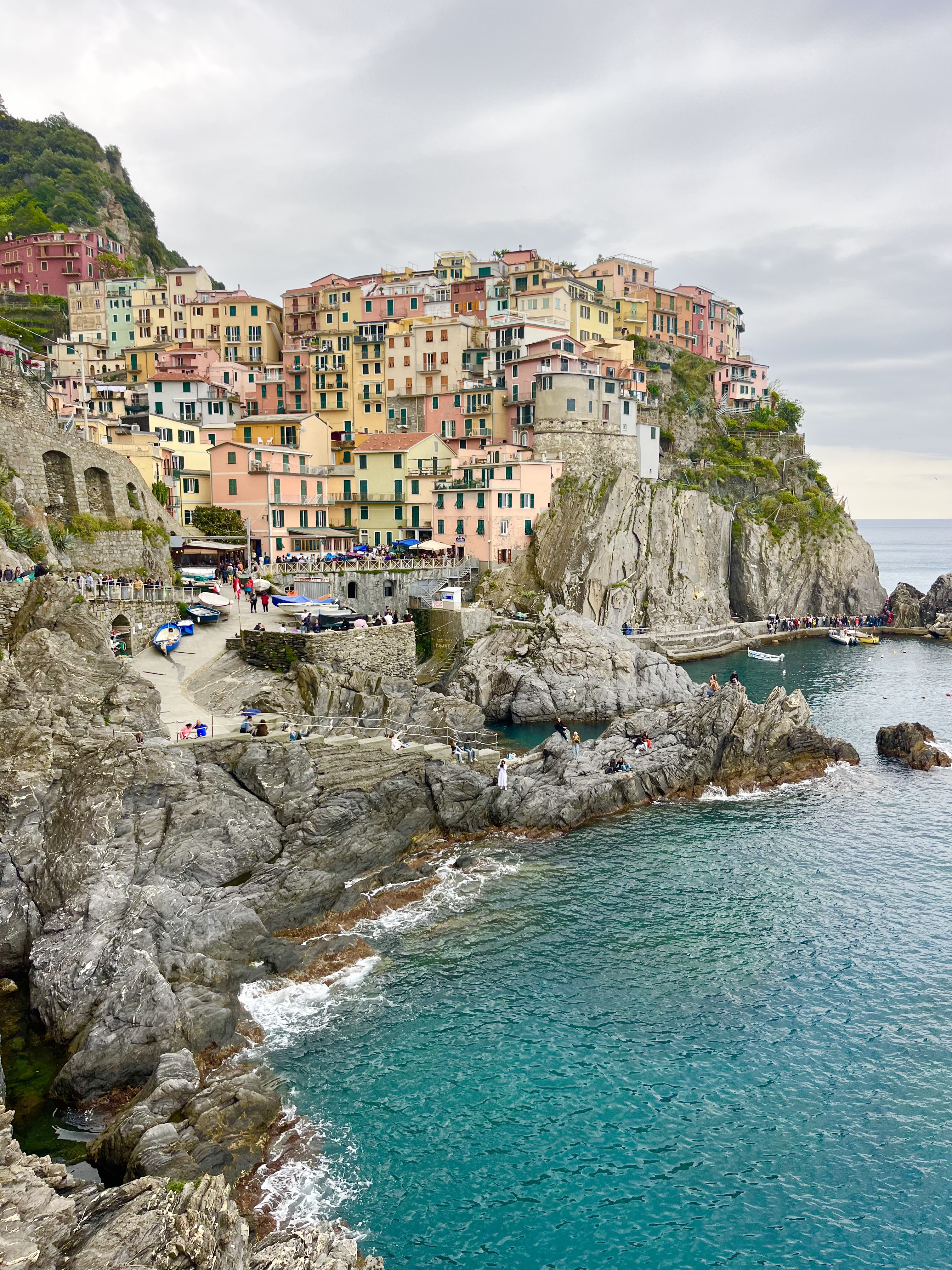Vibrant houses in Italy overlooking the sea, showcasing a picturesque coastal village.