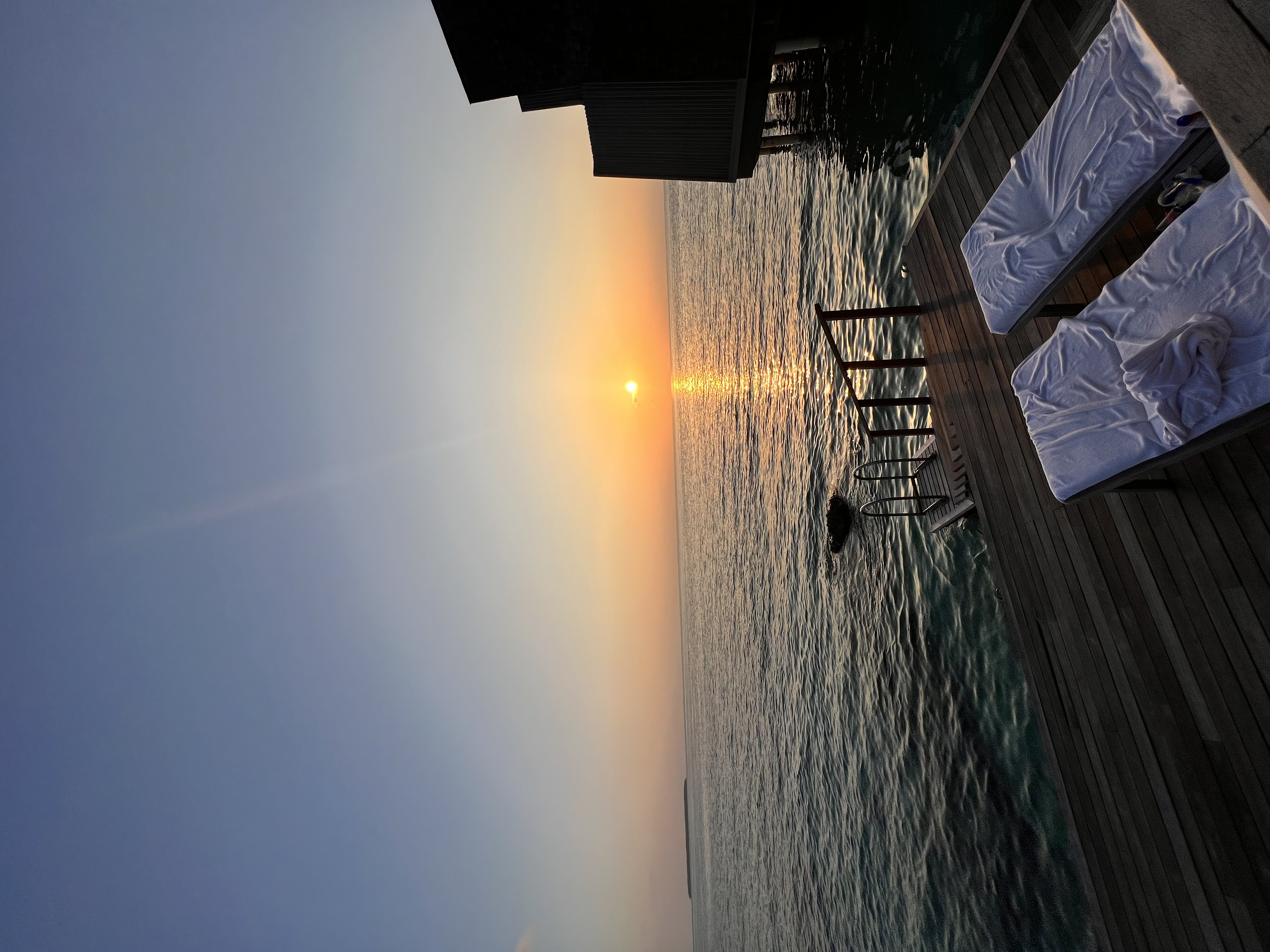 An image of a sunset with the ocean in the distance.