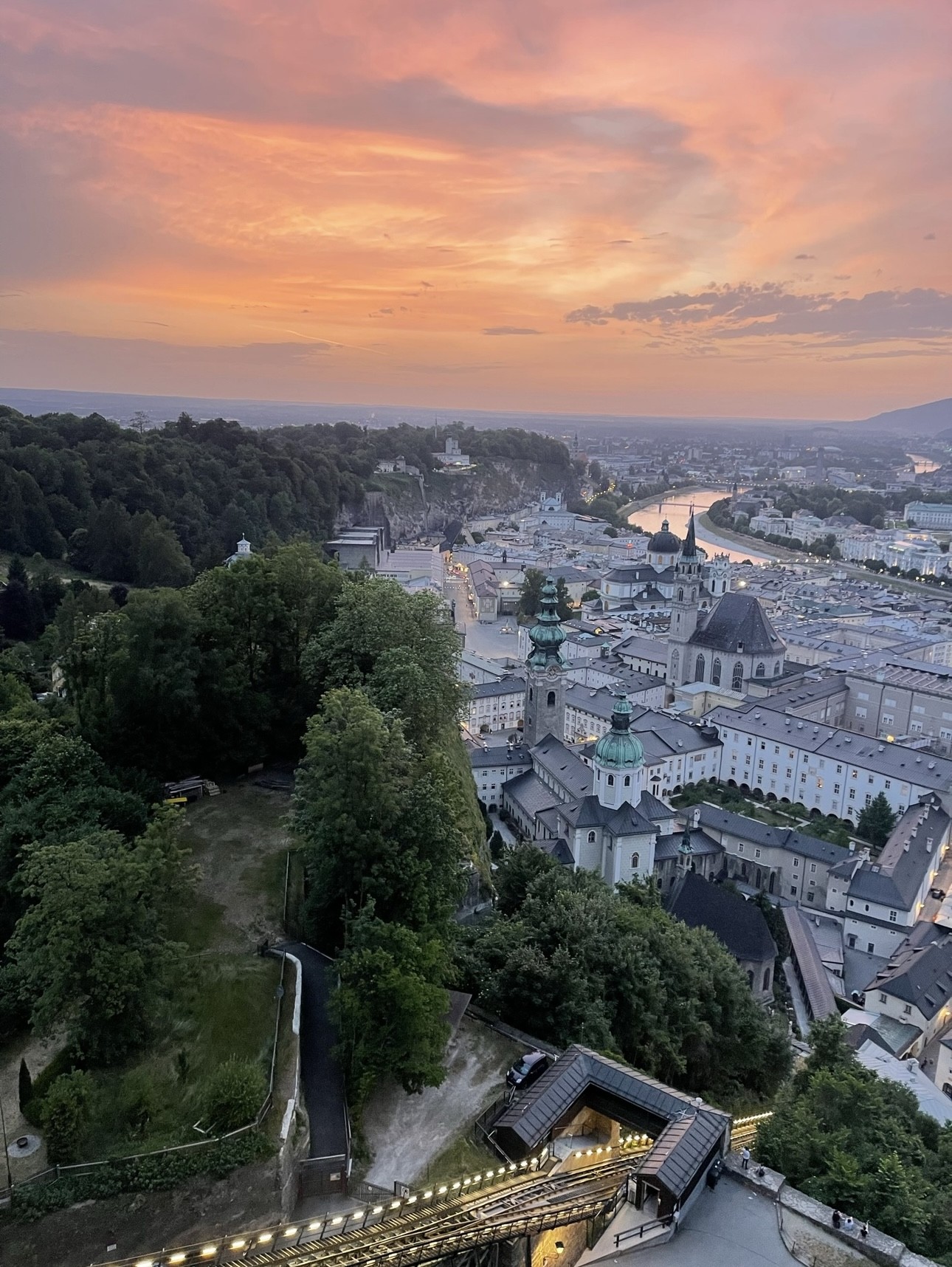 Aerial view of a beautiful cityscape along a river at sunset