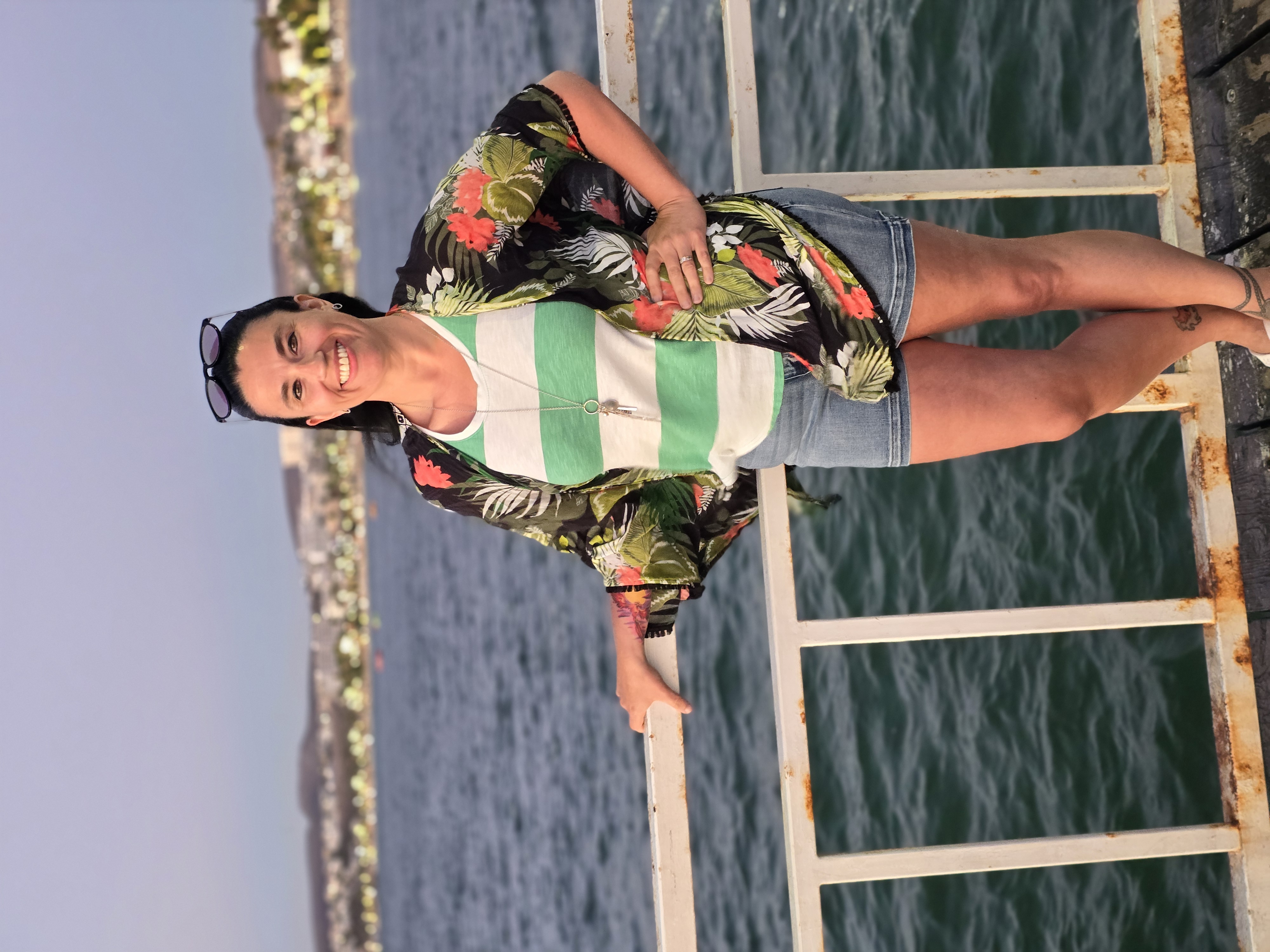 Advisor posing in front of waves lapping at dusk.