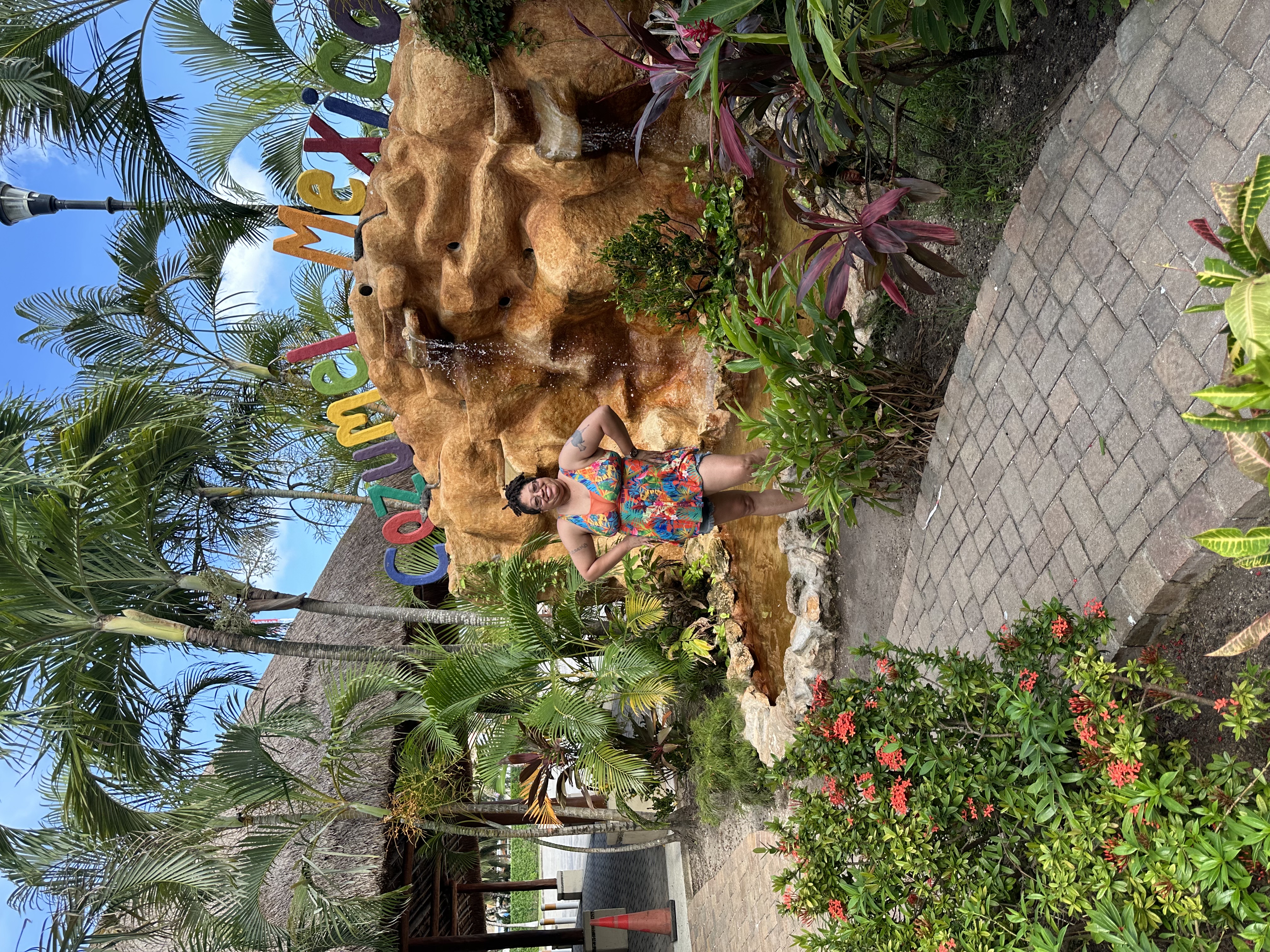 By palm trees by the beach.