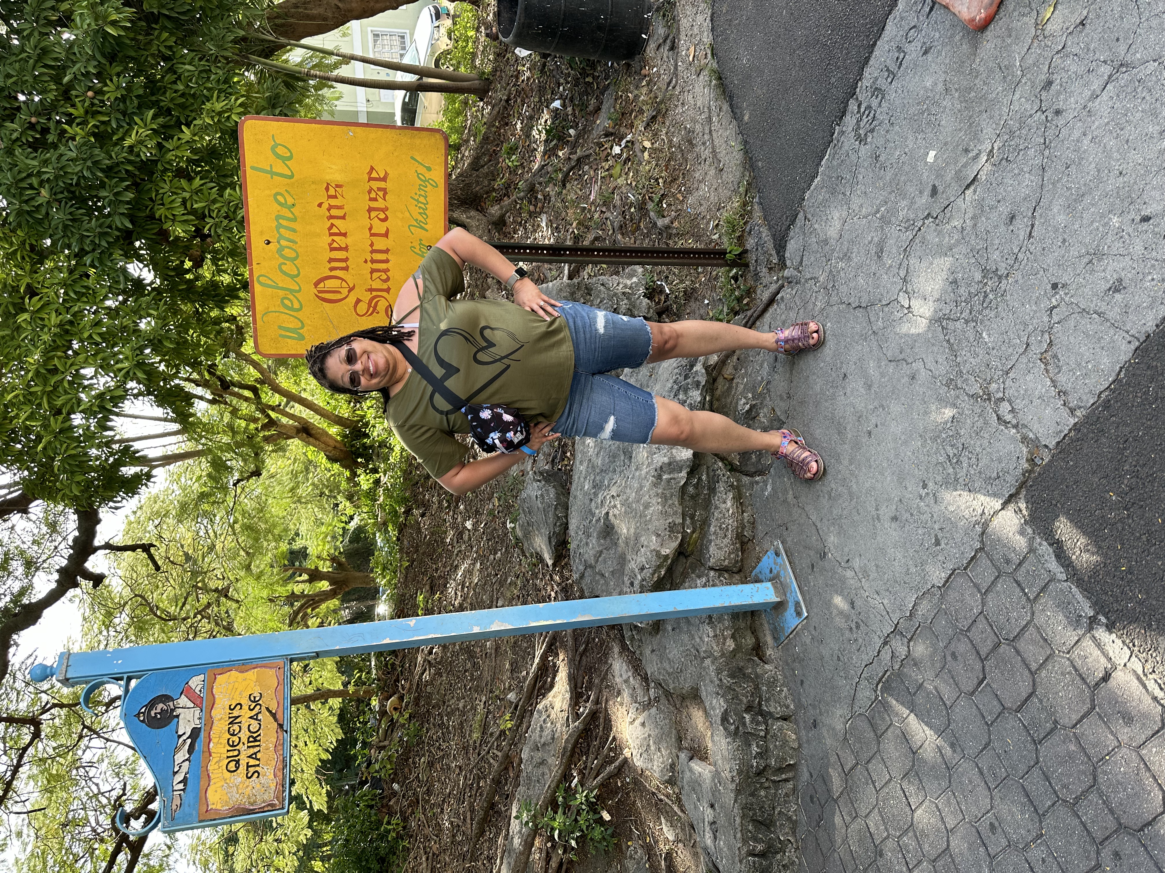 Lady in front of a sign.
