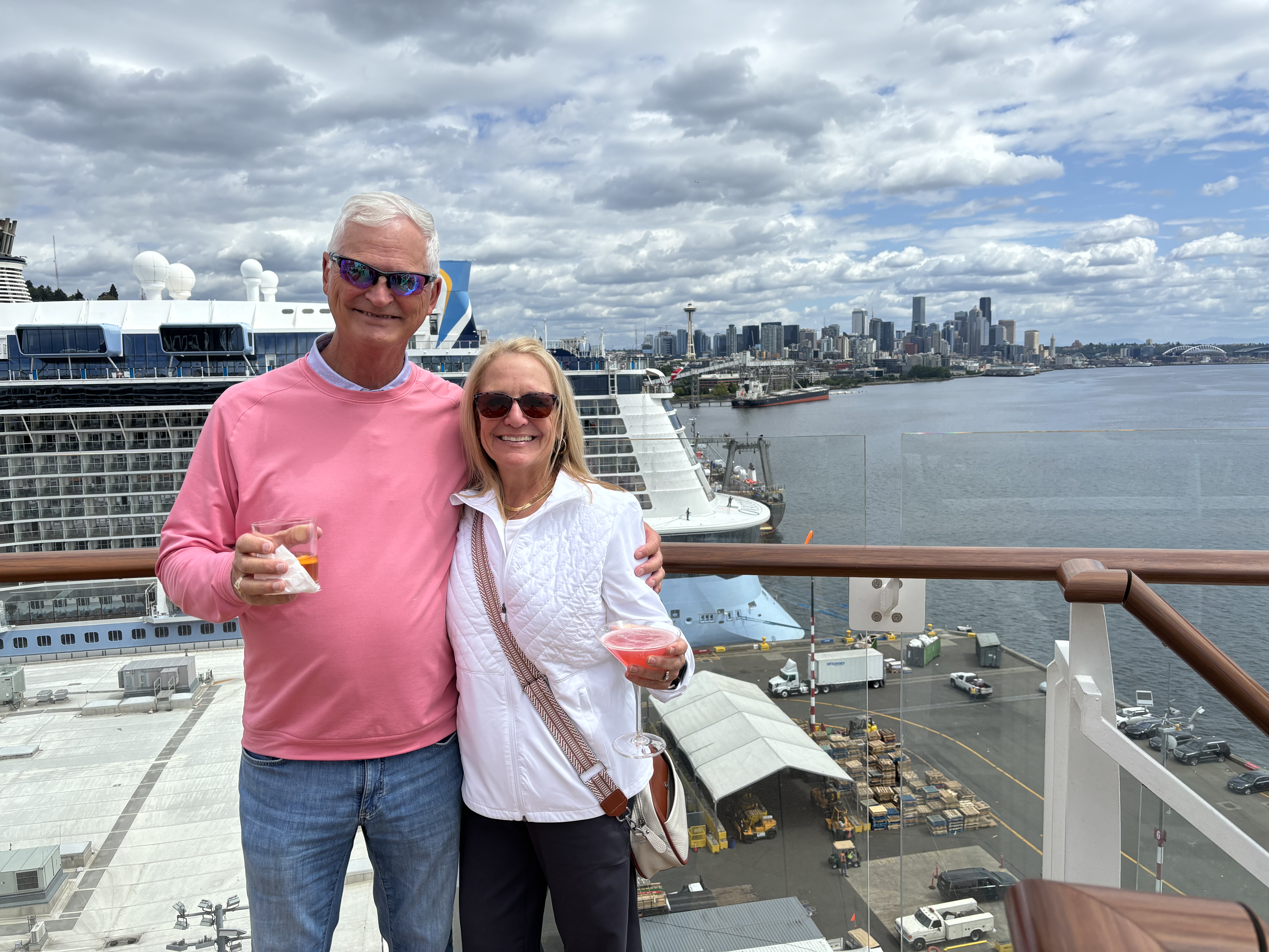A couple posing on a cruise ship in the daytime.