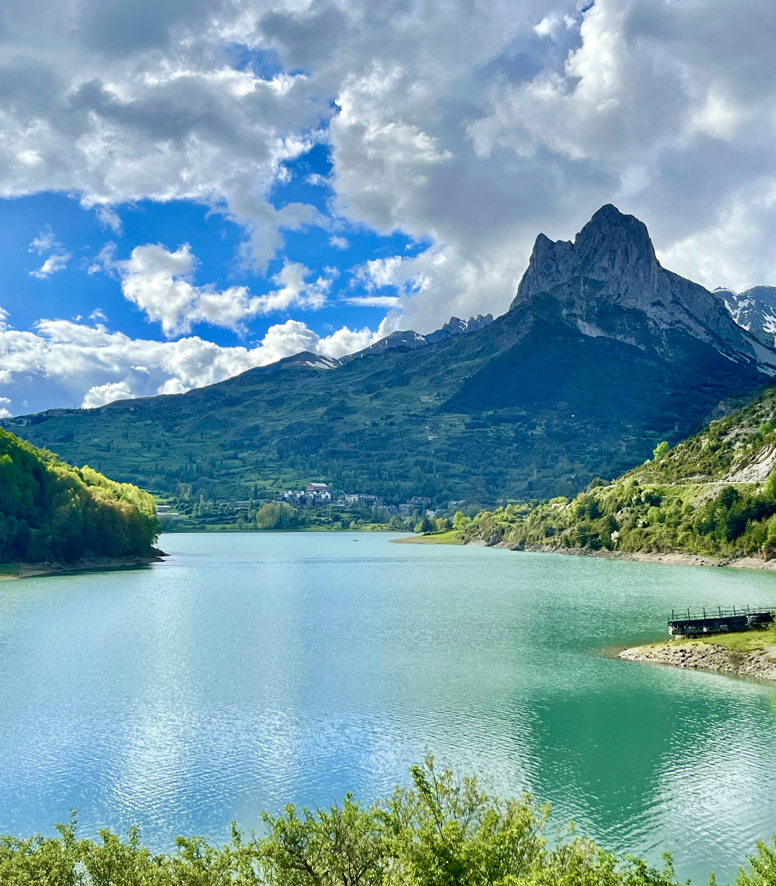 Beautiful tranquil lake surrounded by stunning mountain scenery on a sunny day