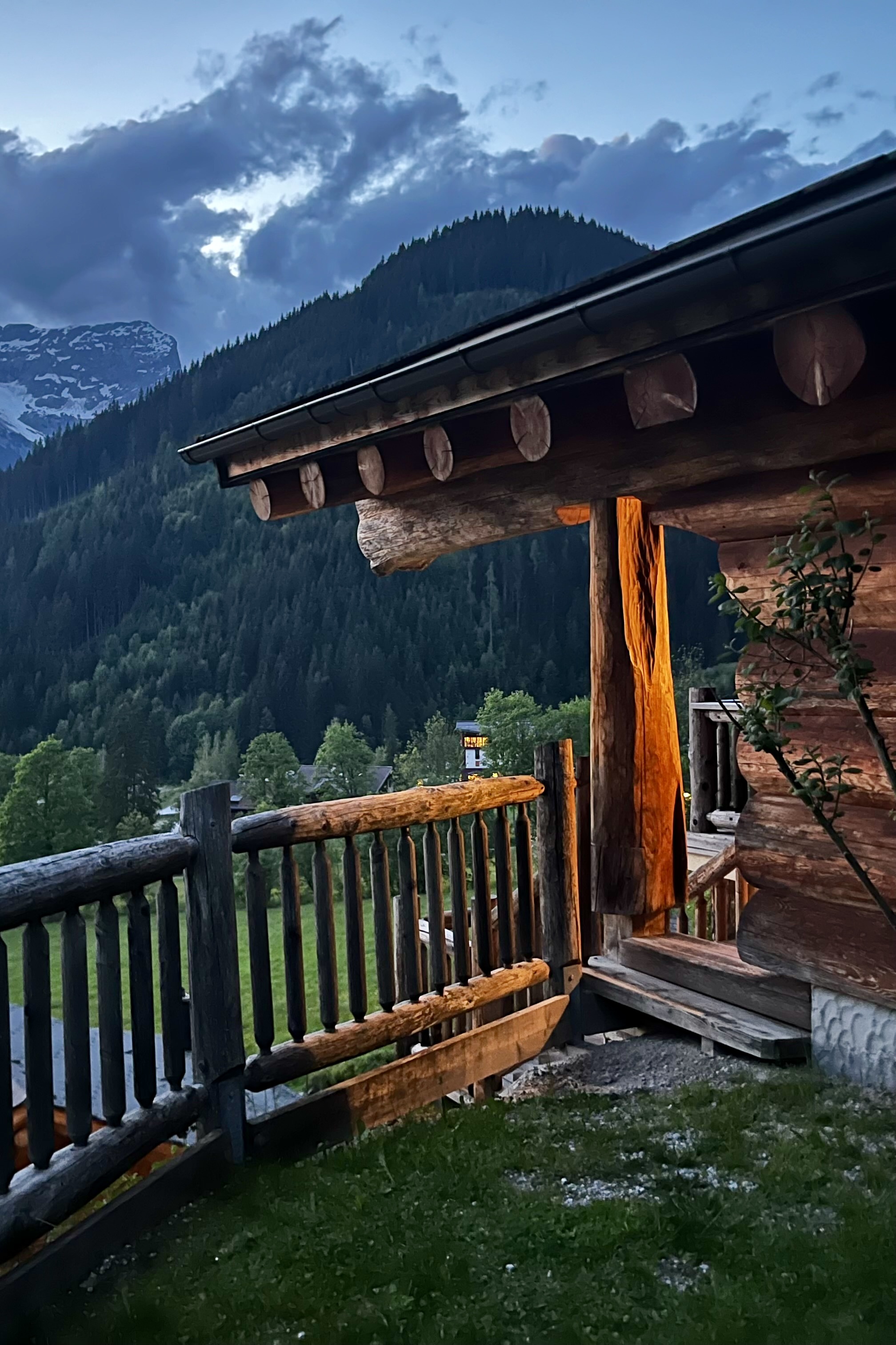 View of a wooden temple-like building amidst the mountains at dusk