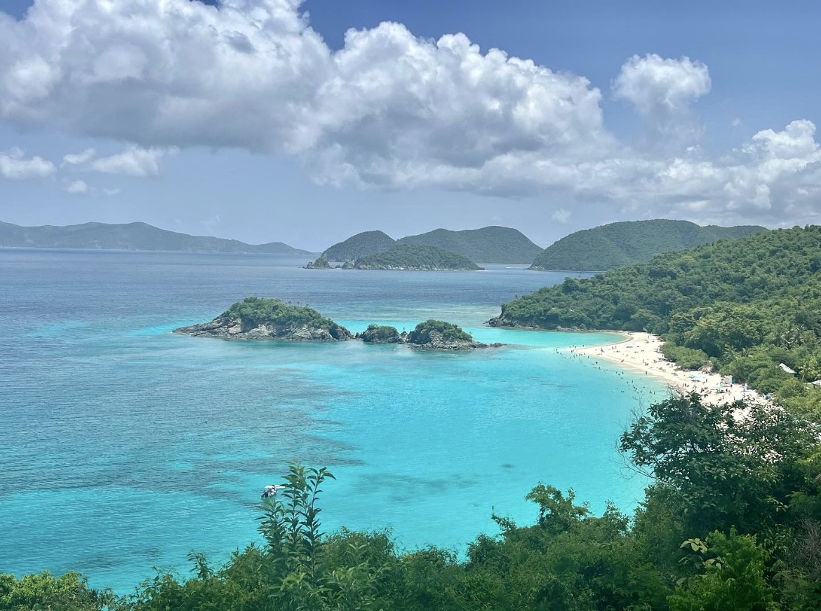 Crystal-clear waters surrounded by lush islands create a perfect picture of relaxation on a cloudy day.