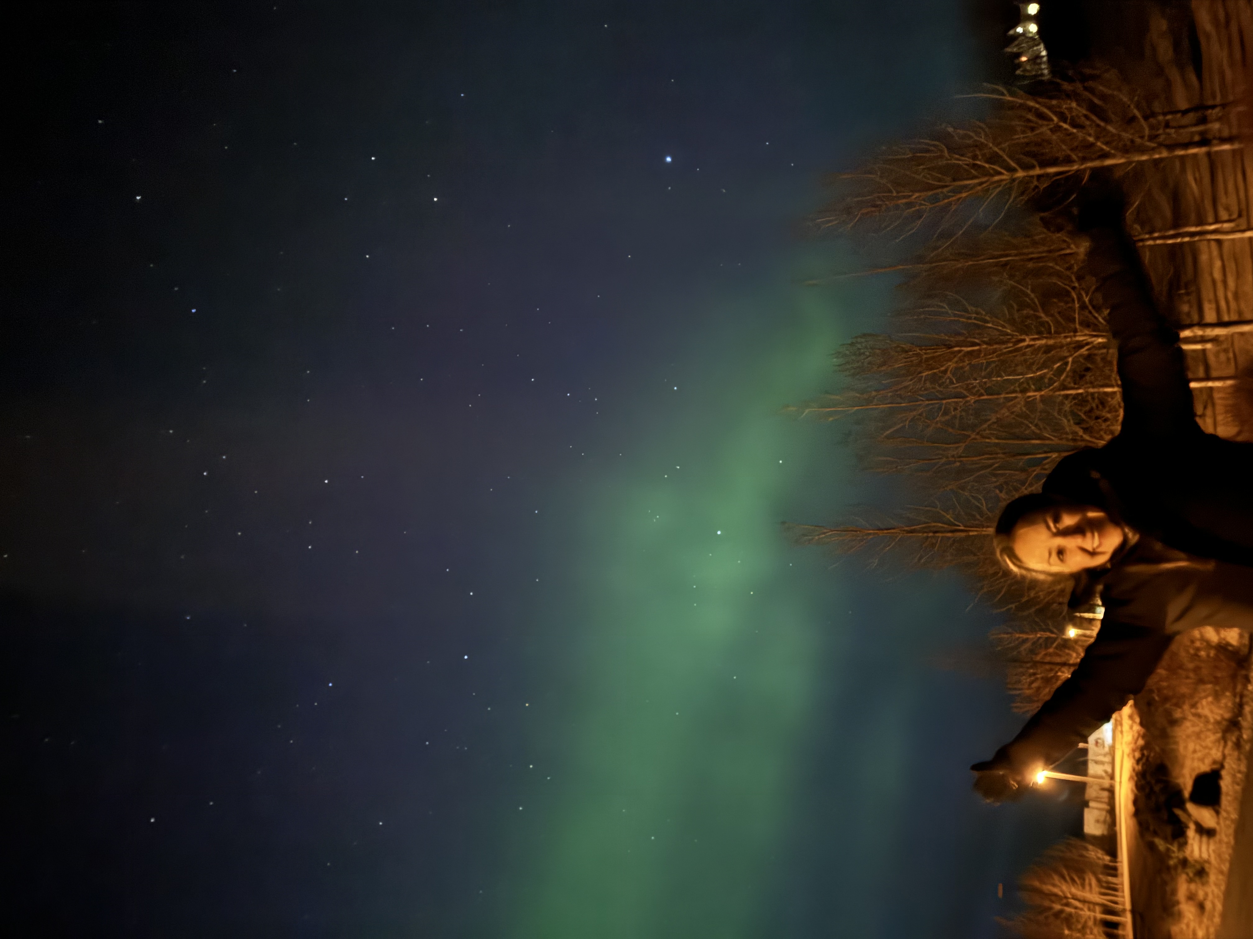 Karla posing in front of the Northern Lights.
