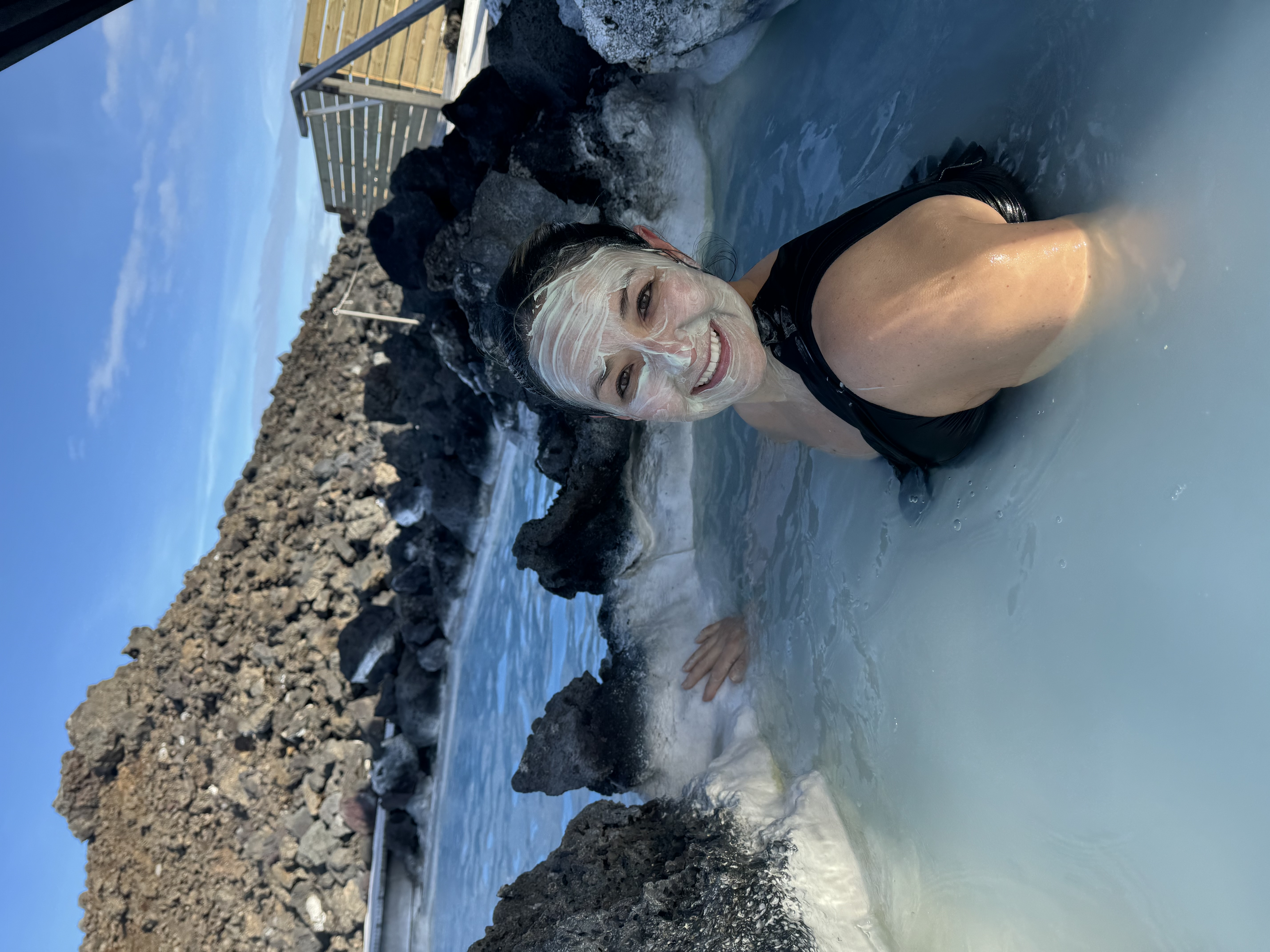 Karla in a pool, surrounded by rocks during the daytime.