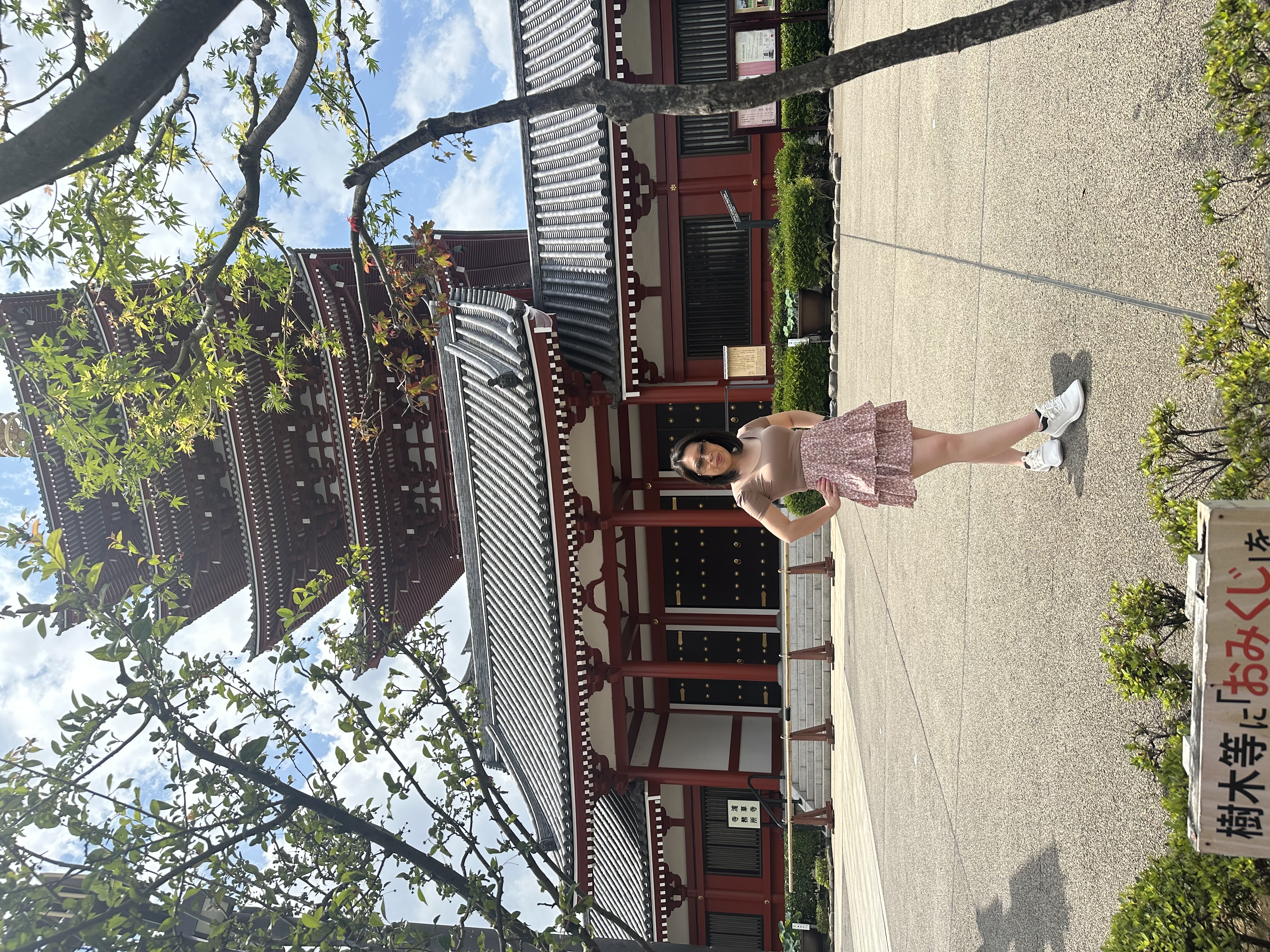 Advisor posing with hands on hips outdoors in front of a Japanese temple