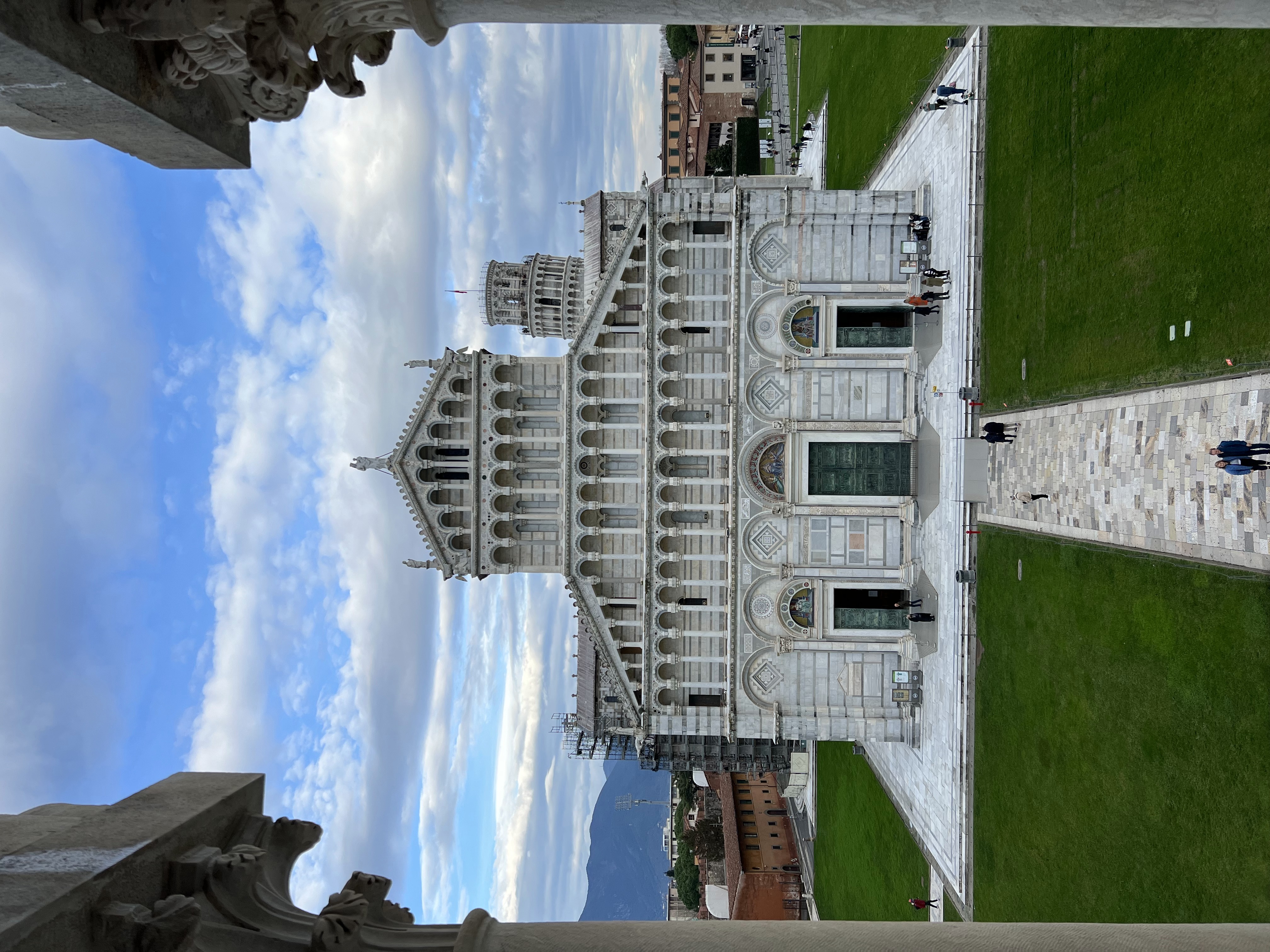 A beautiful white temple with a white path and manicured lawn in front of it.