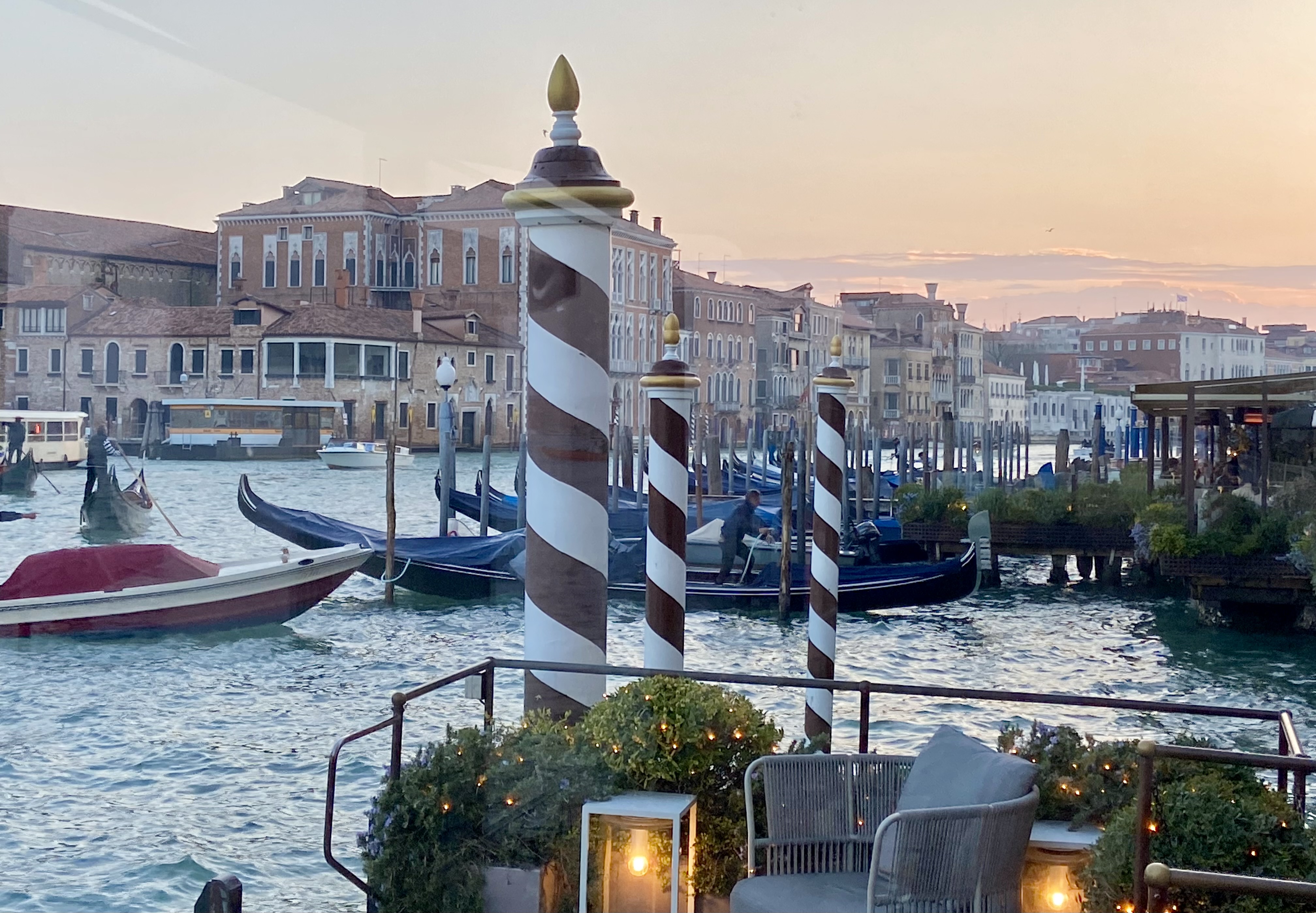 View of the city with boats in the water during sunset.