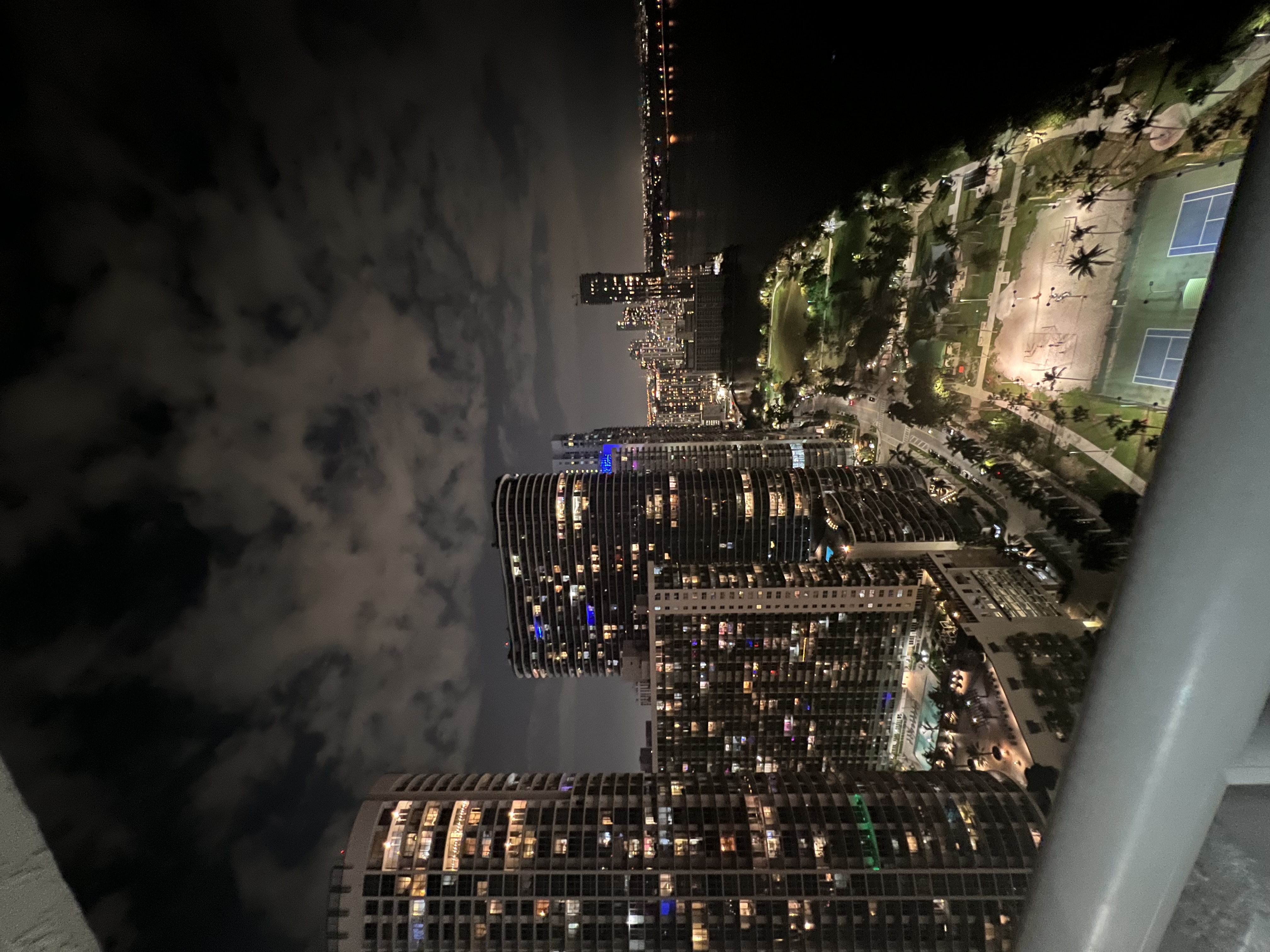 Skyline view of lit up buildings in the city during the nighttime.