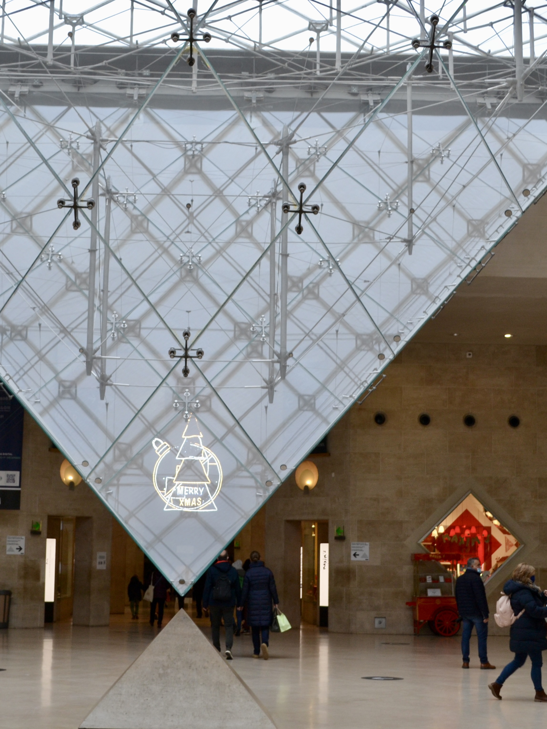 A view of the inside of a building with a large art display.