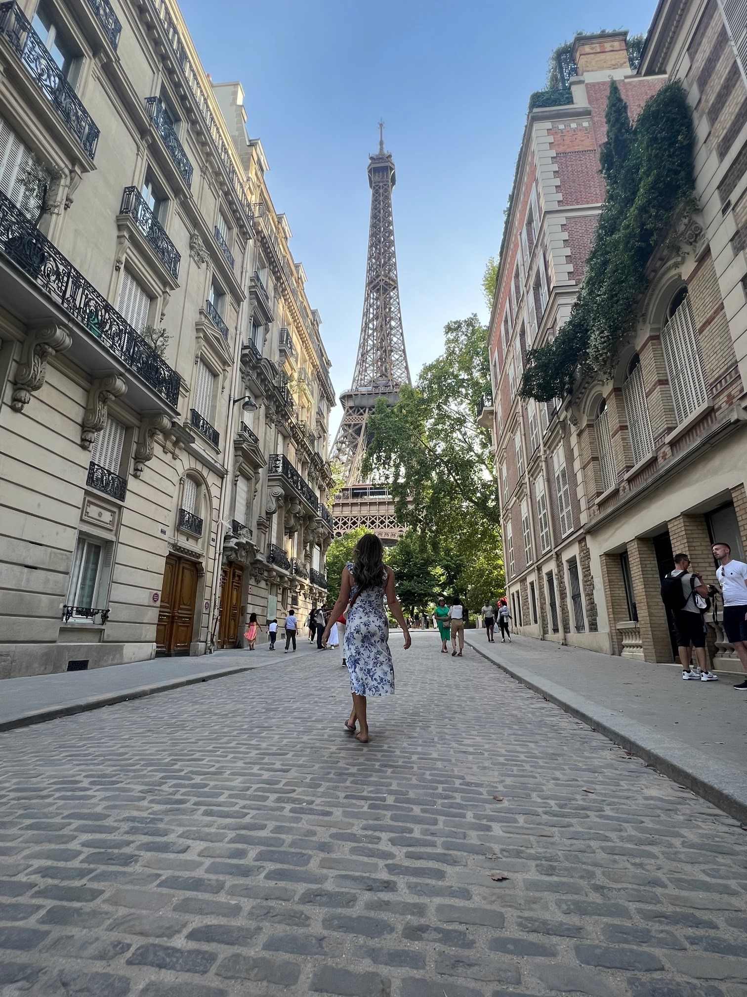 Advisor walking down the street with the Eiffel Tower in the distance.