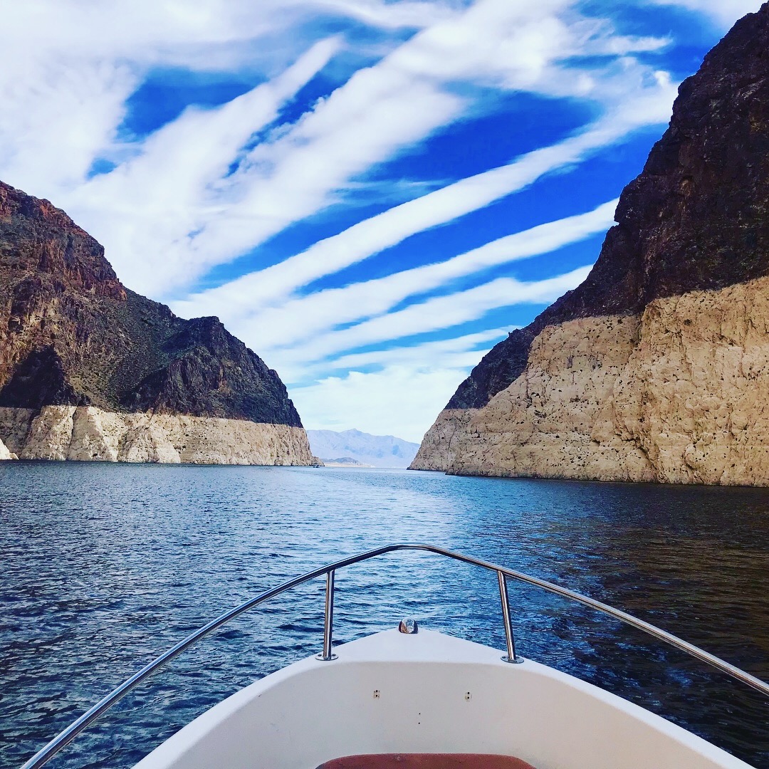 A view of the ocean with cliffs in the distance.
