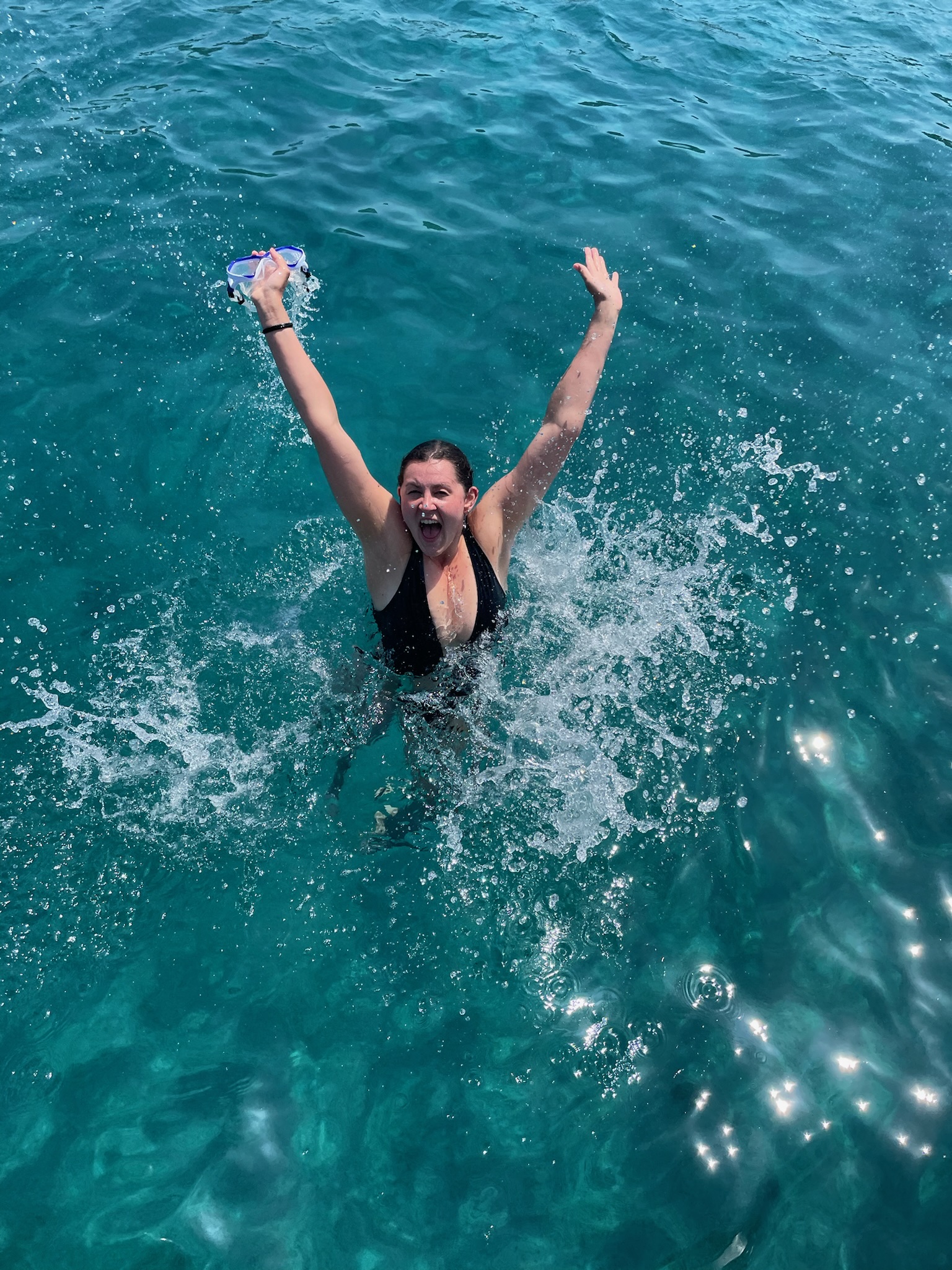Advisor in the ocean with arms raised