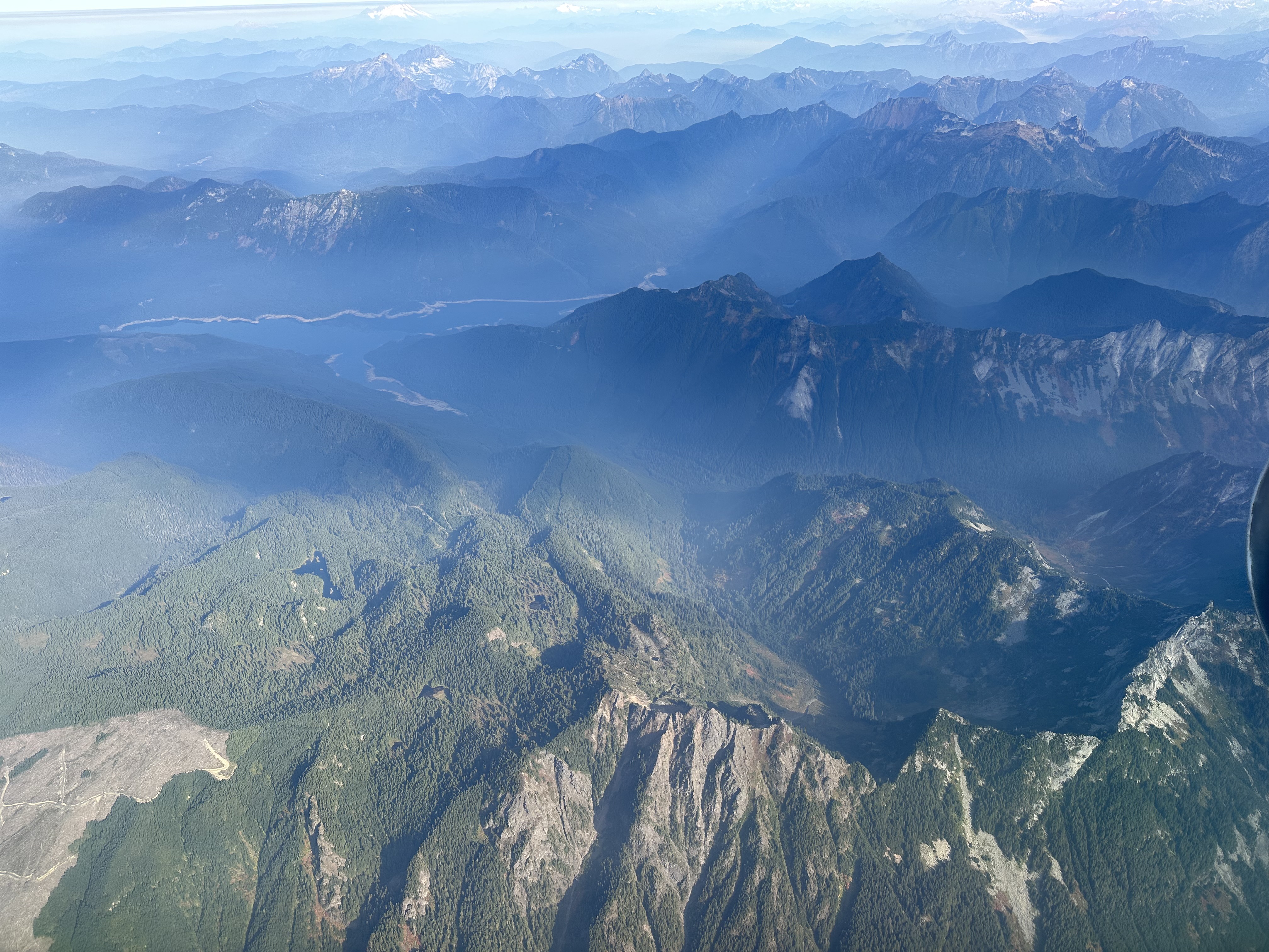 Aerial view of a beautiful green mountain range on a sunny day