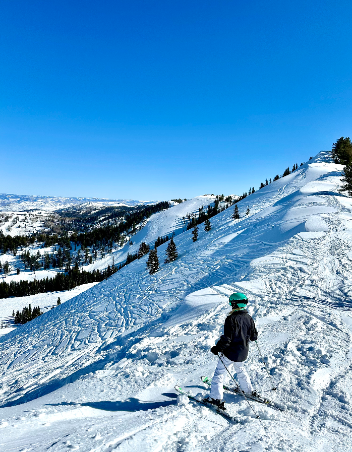 A person skiing on snow-covered slopes