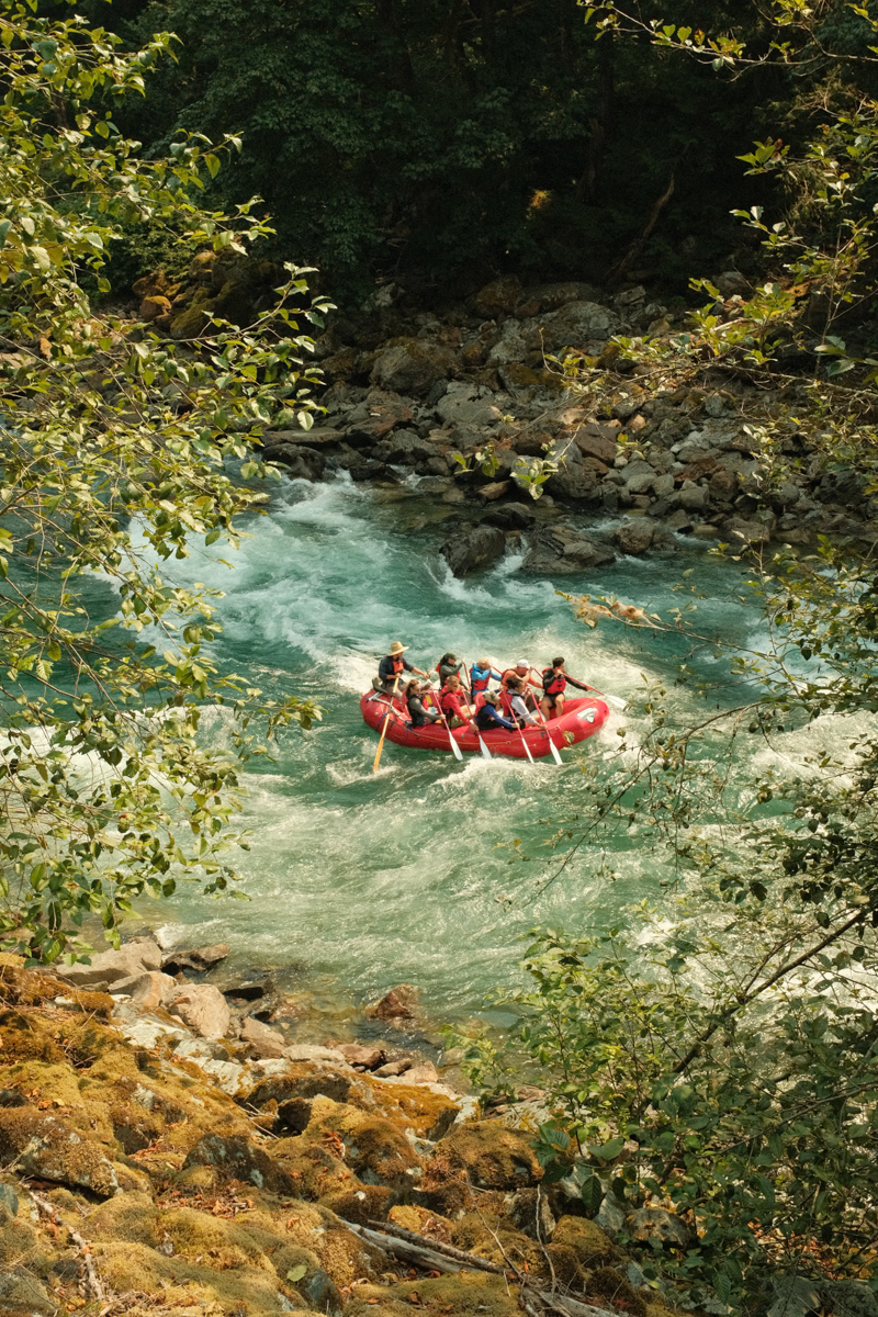 View from above of a group of people white water rafting