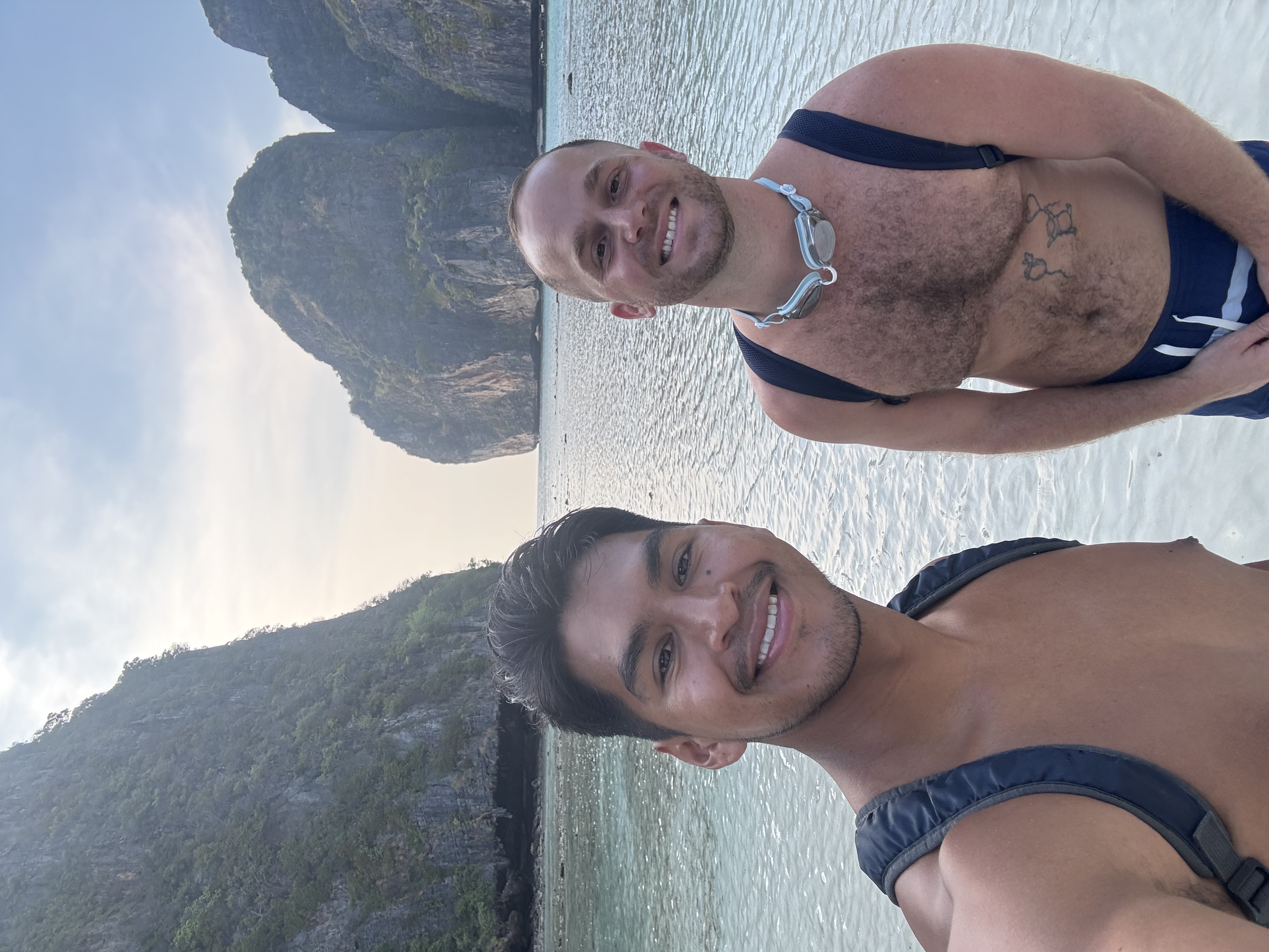 Jeffrey and friend posing with the ocean in the background.