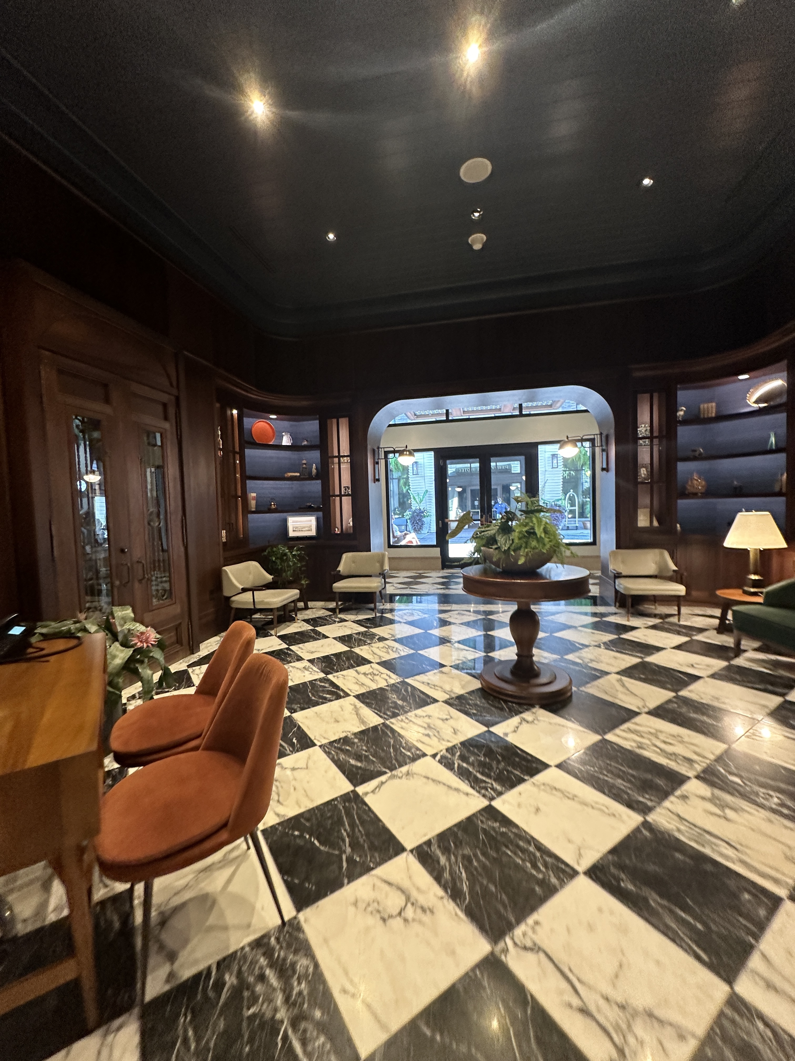 View of a black and white tile floor in a hotel lobby