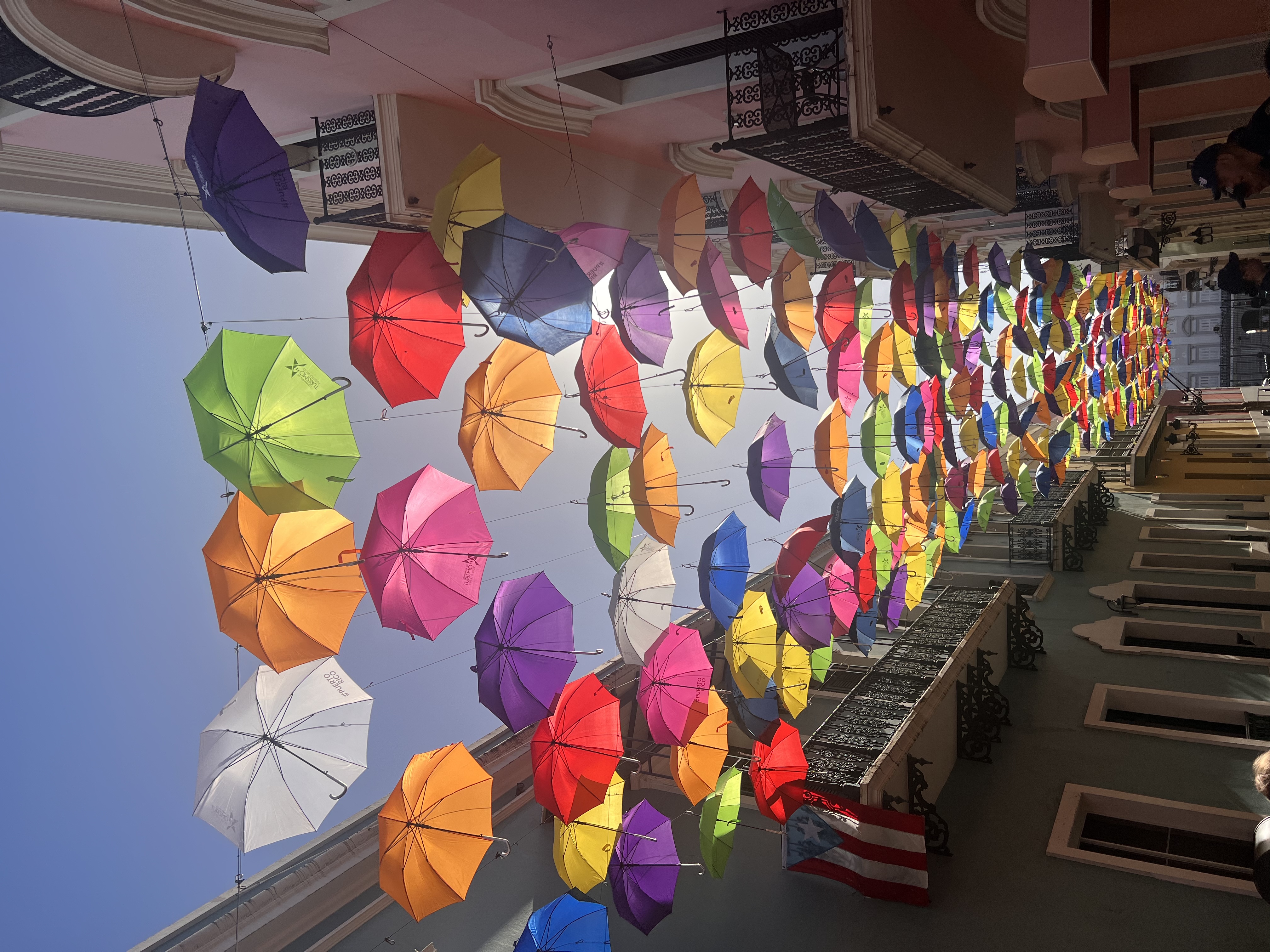 View of colorful umbrellas hanging above the street on a sunny day in Old San Juan