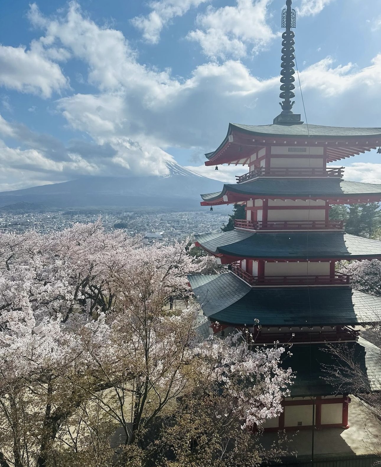 View of Japanese temple overlooking a valley with a large volcano visible on the horizon