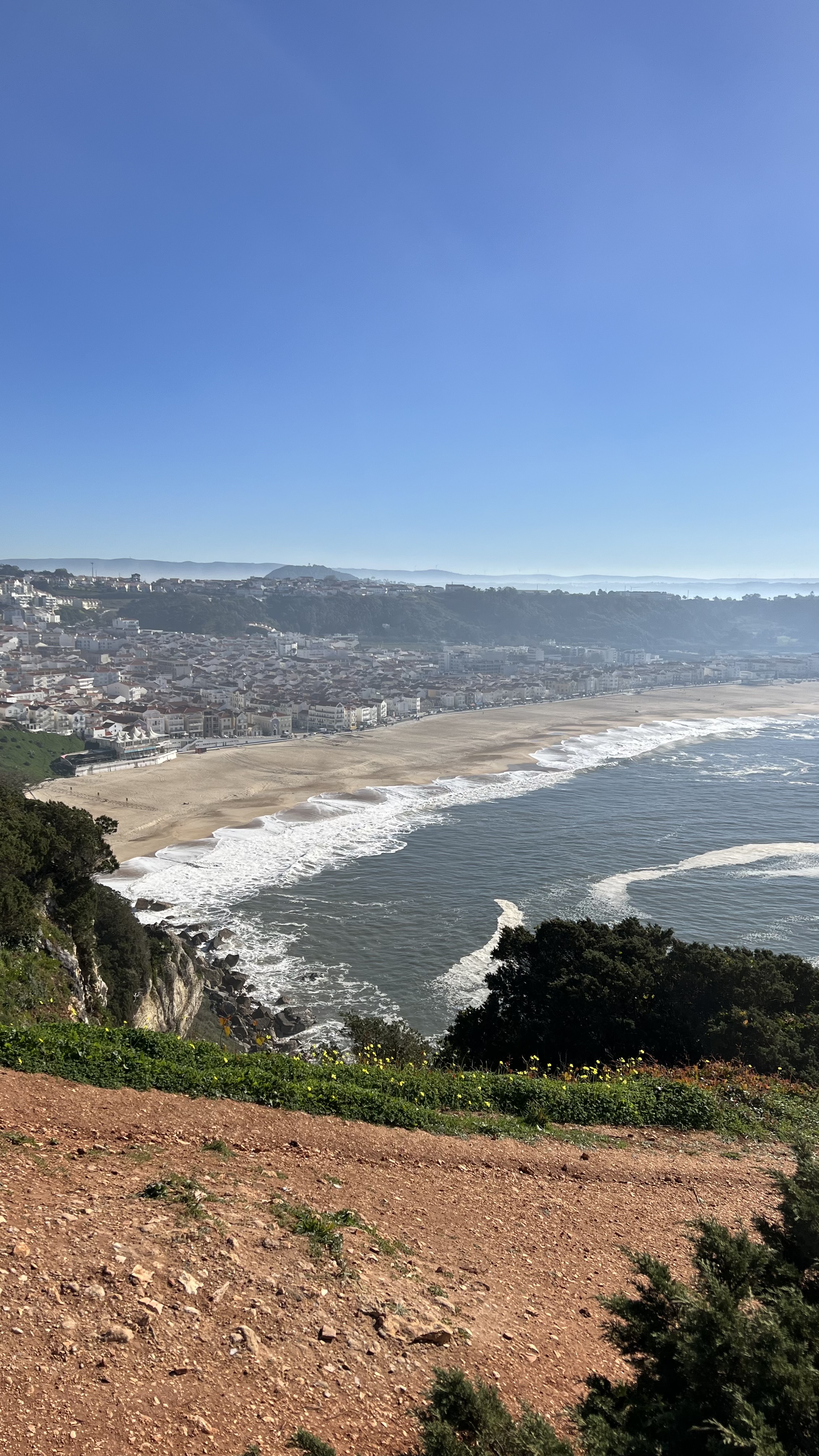 View of a wide sandy beach as seen from above on a clear day
