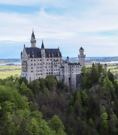 A picturesque view of Neuschwanstein Castle, nestled in the Bavarian landscape of Germany, exuding enchanting charm.