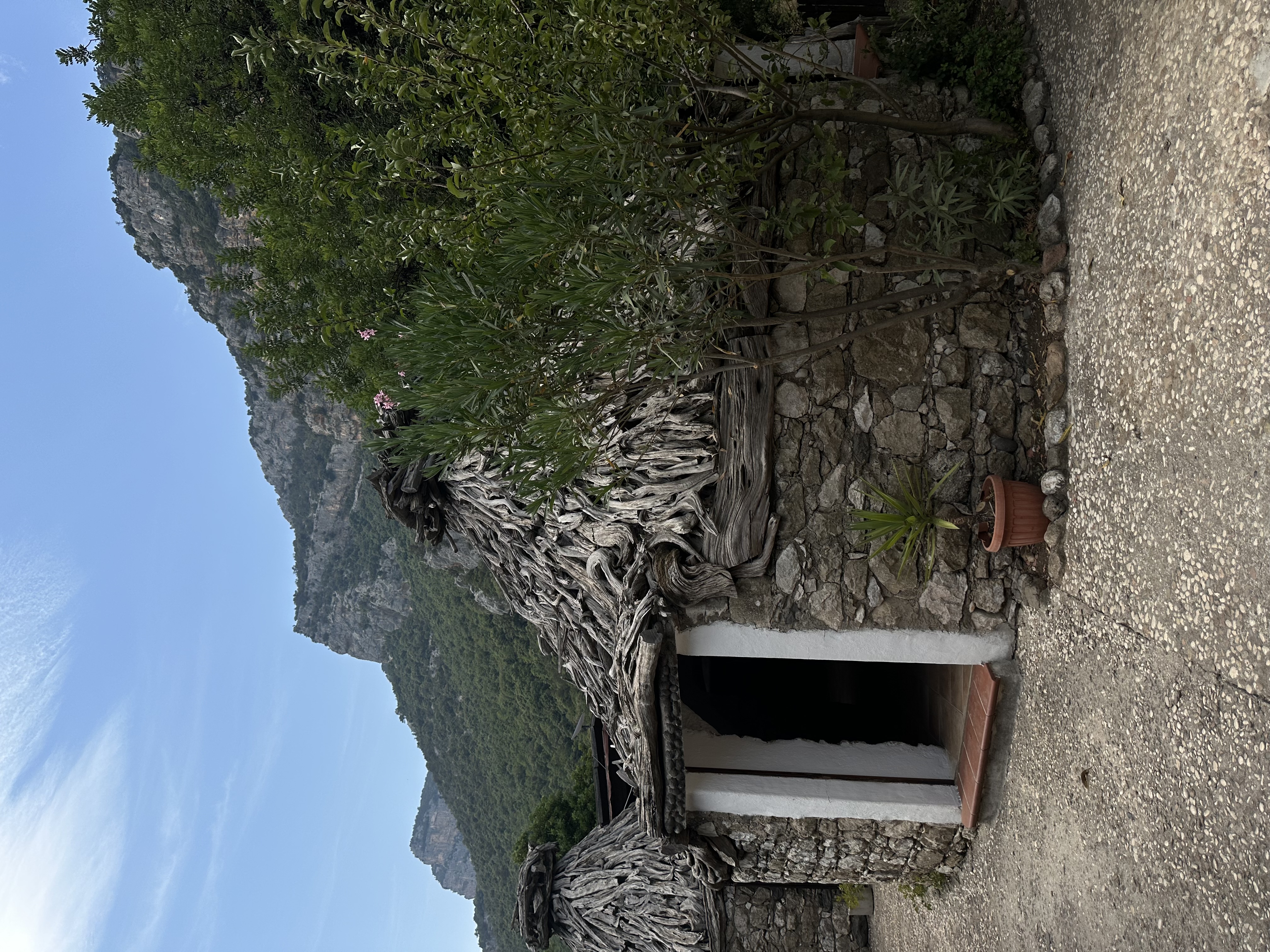 View of a doorway leading into a circular stone hut in the mountains