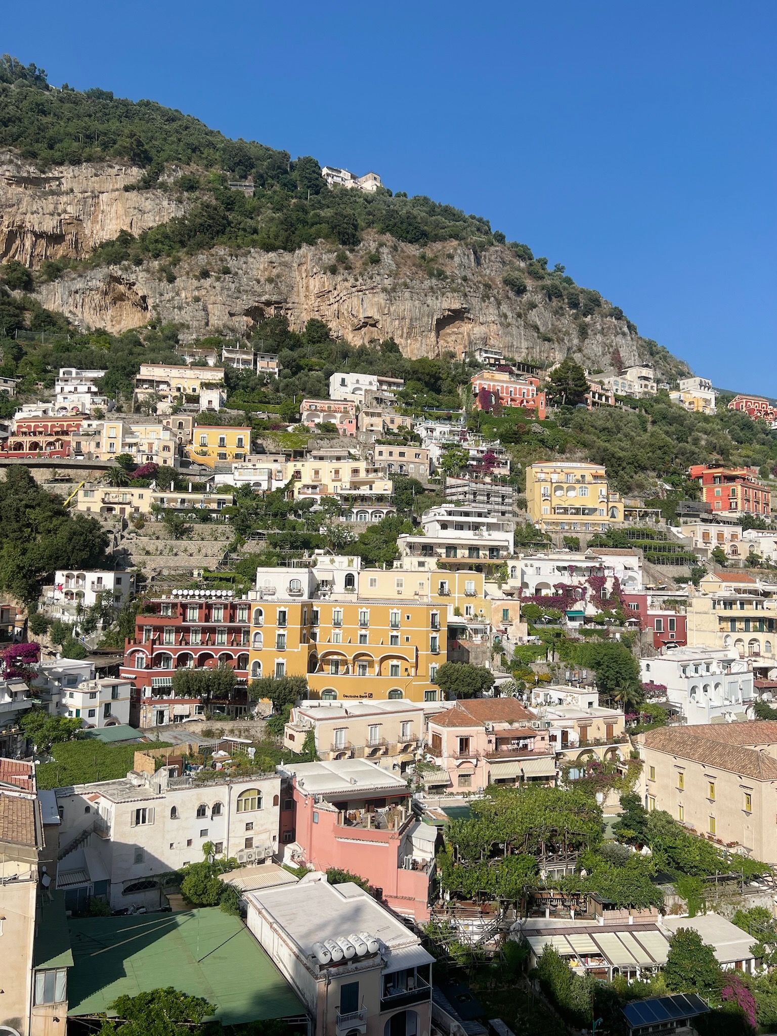 Colorful buildings on the side of a cliff during the daytime