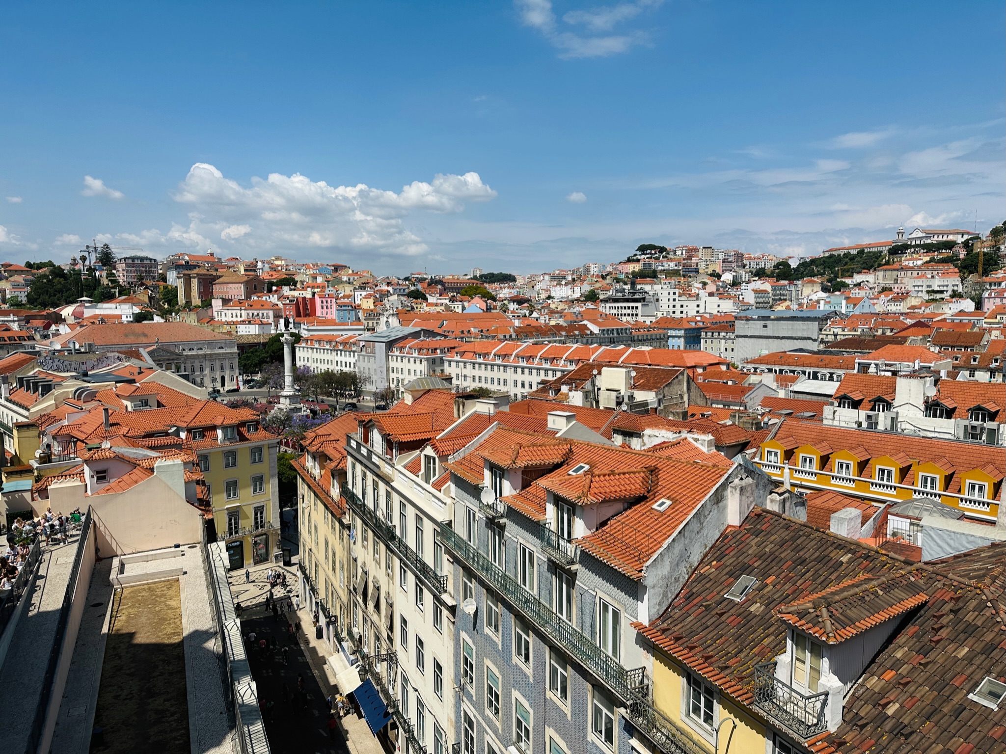 View of orange-tiled rooftops in a sunny city