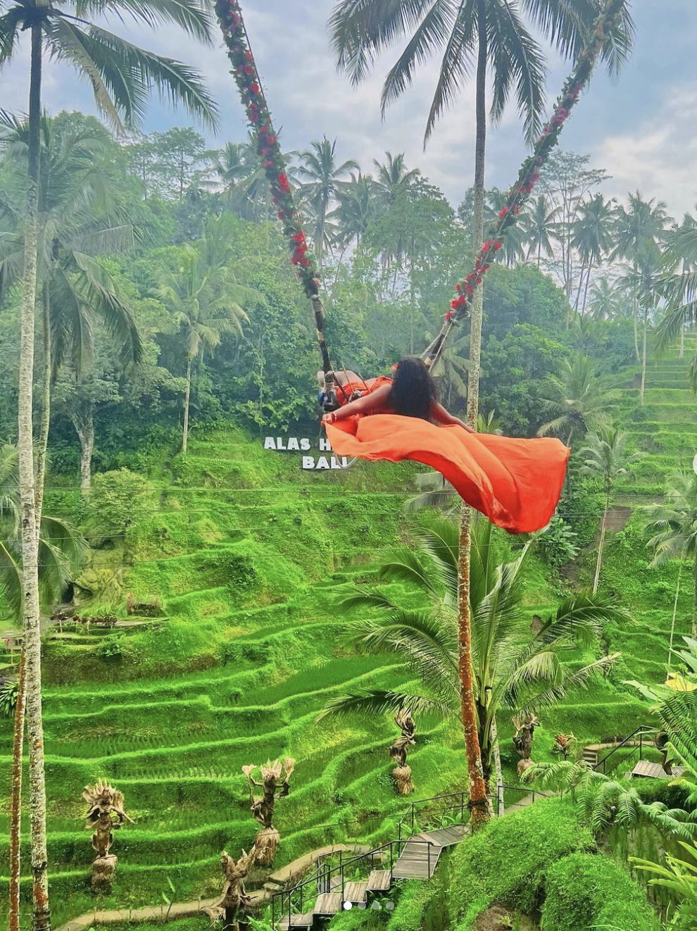 Advisor on a swing in the jungle overlooking lush green rice terraces