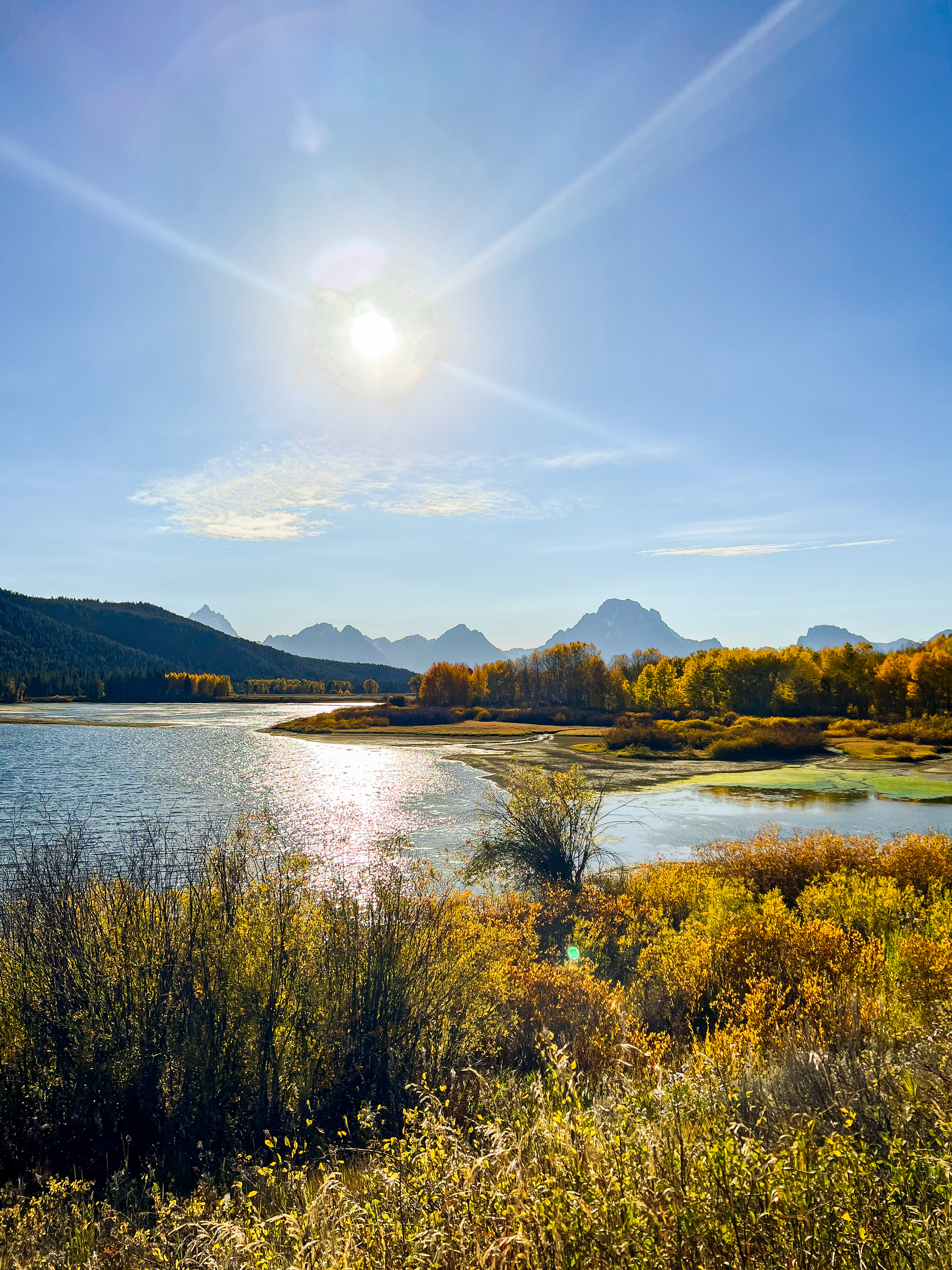 View of lakes with mountains in the distance on a sunny day