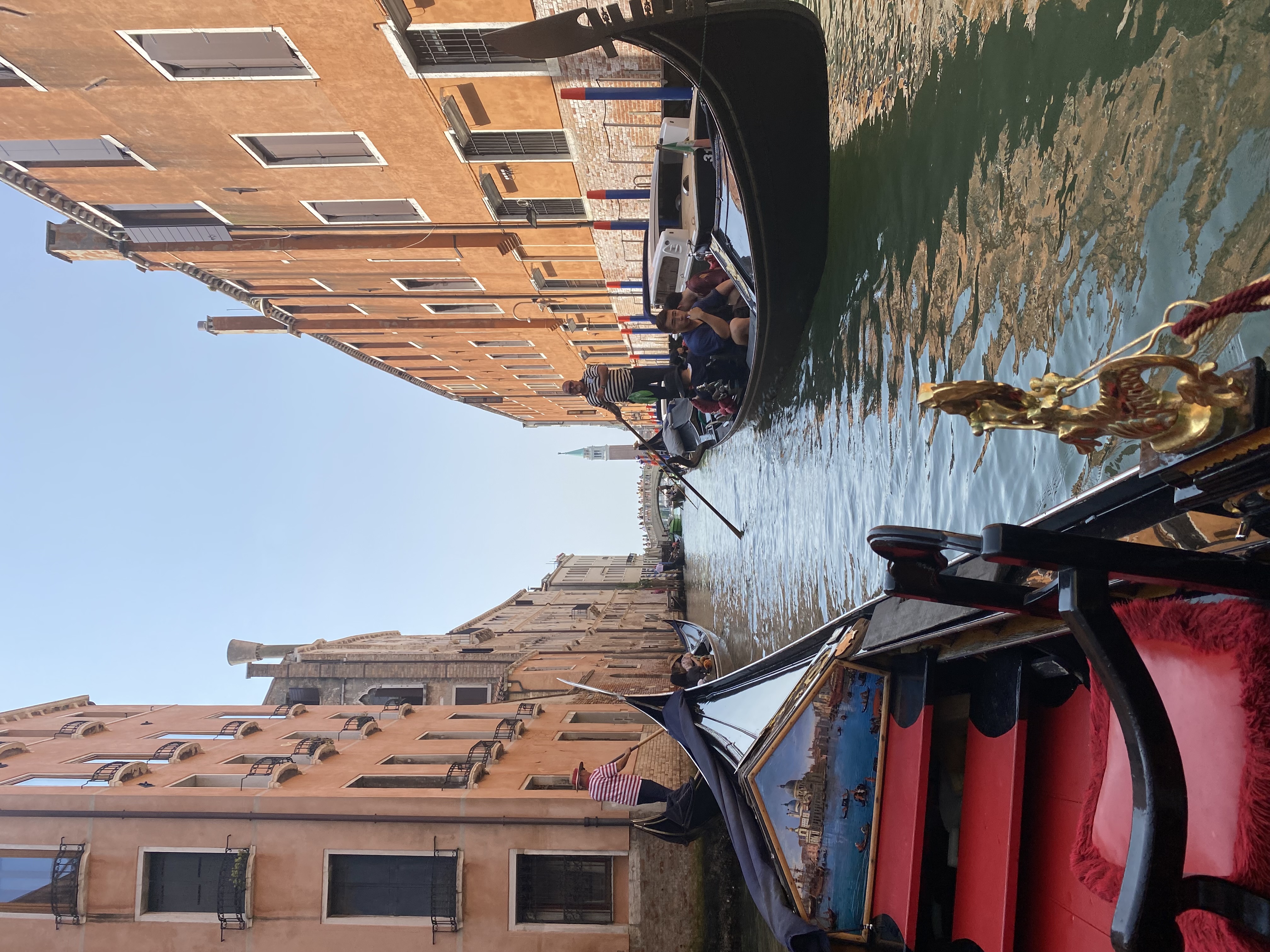 View from a gondola on a canal on a sunny day in Venice, Italy
