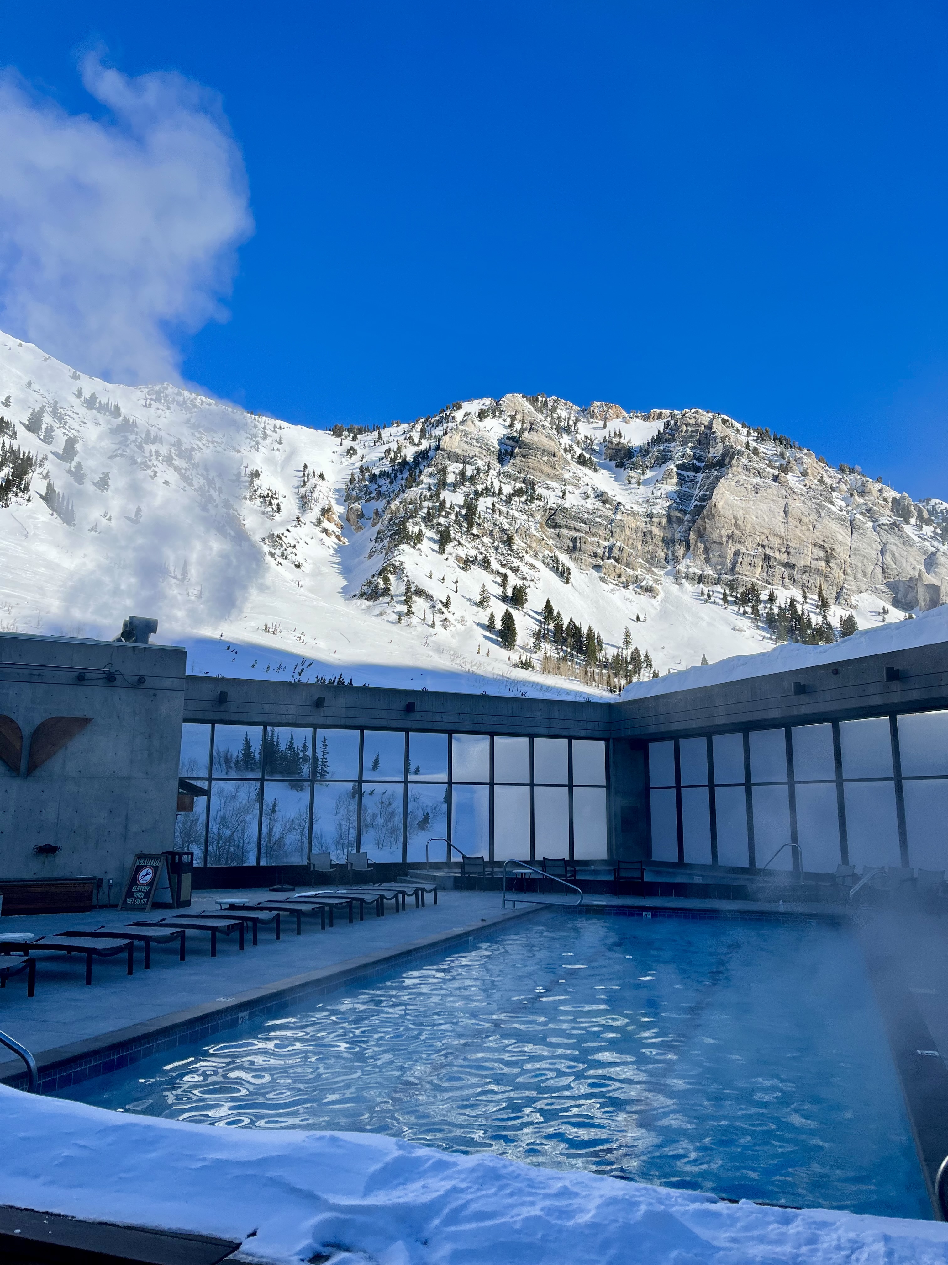 View of a resort pool in the snowy mountains on a clear day