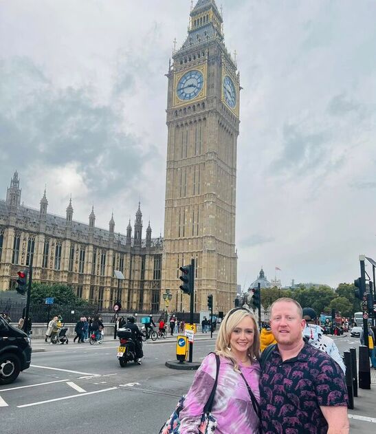 Advisor and partner posing together in front of Big Ben on a cloudy day in London