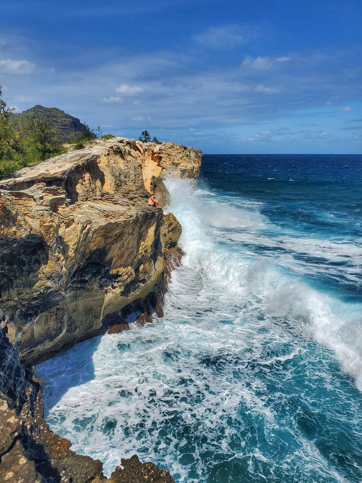Waves by cliff.