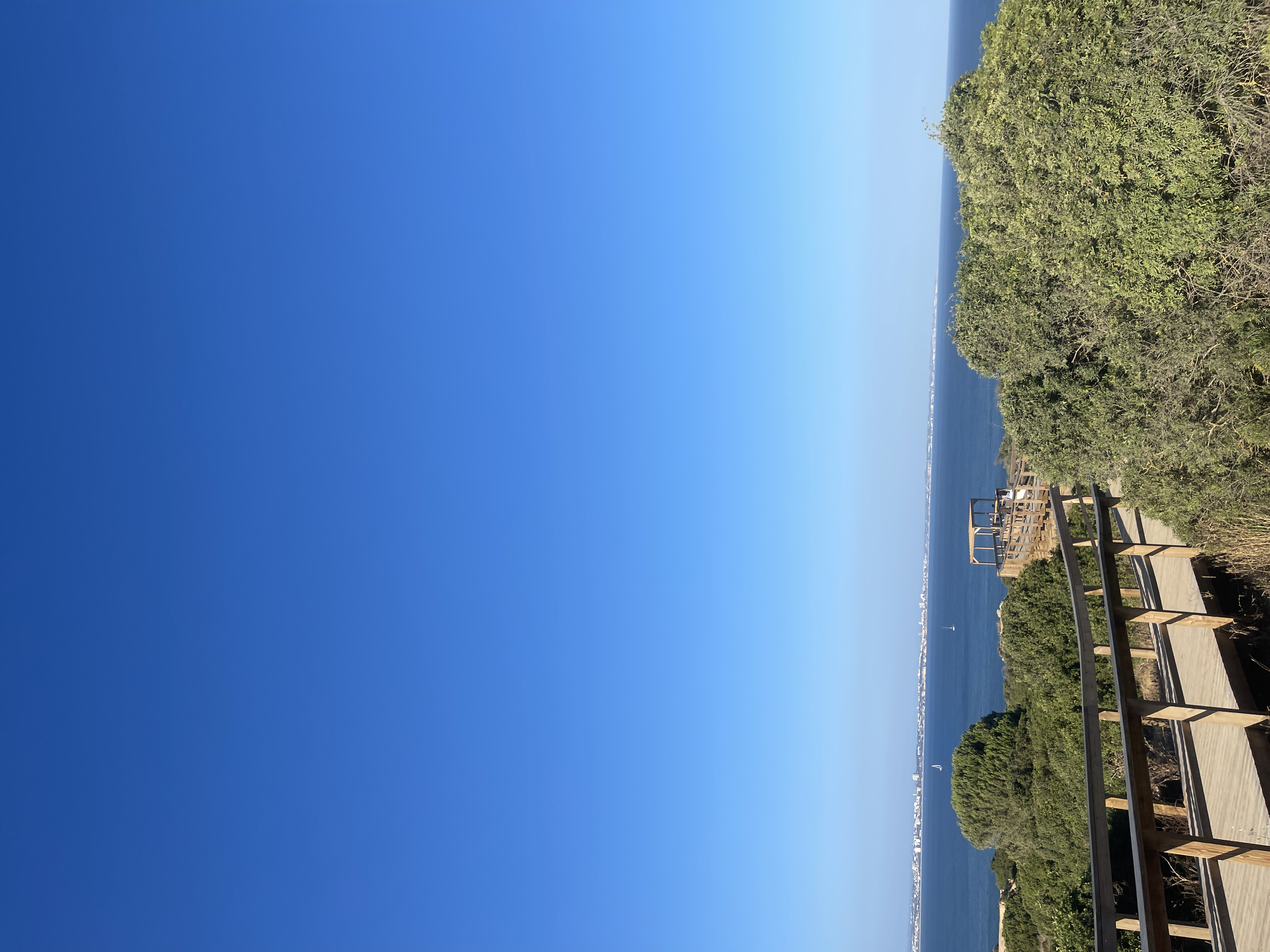 View of a clear blue sky and the sea in the distance